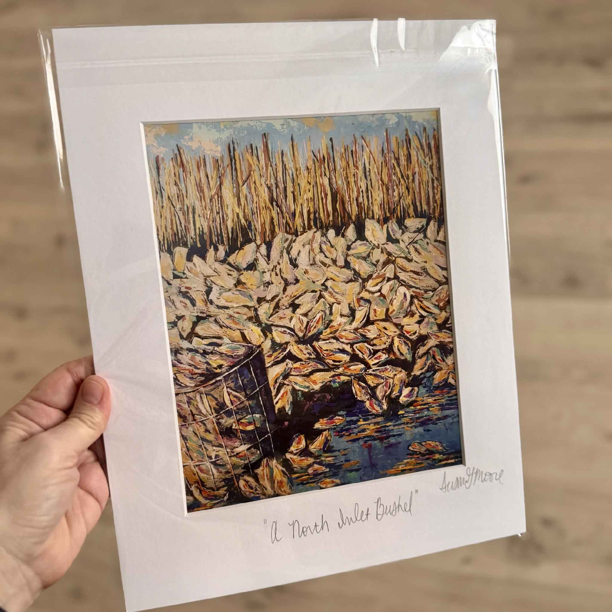 11x14 matted fine art giclée print A North Inlet Bushel by Susan Moore featuring a pile of oysters beside a wire basket and marsh reeds, inspired by coastal South Carolina.