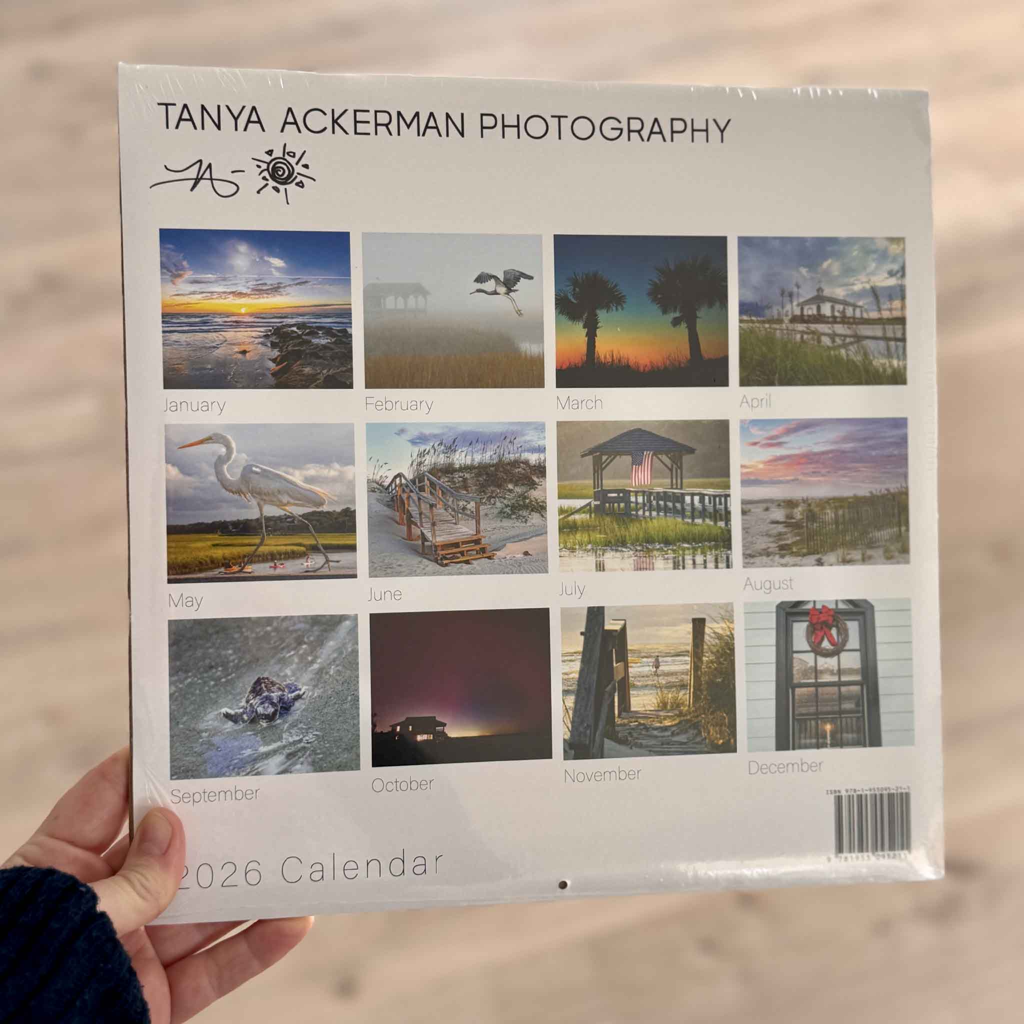Back view of the 2026 photography calendar by local artist Tanya Ackerman showing all monthly images, photographed at Gray Man Gallery.