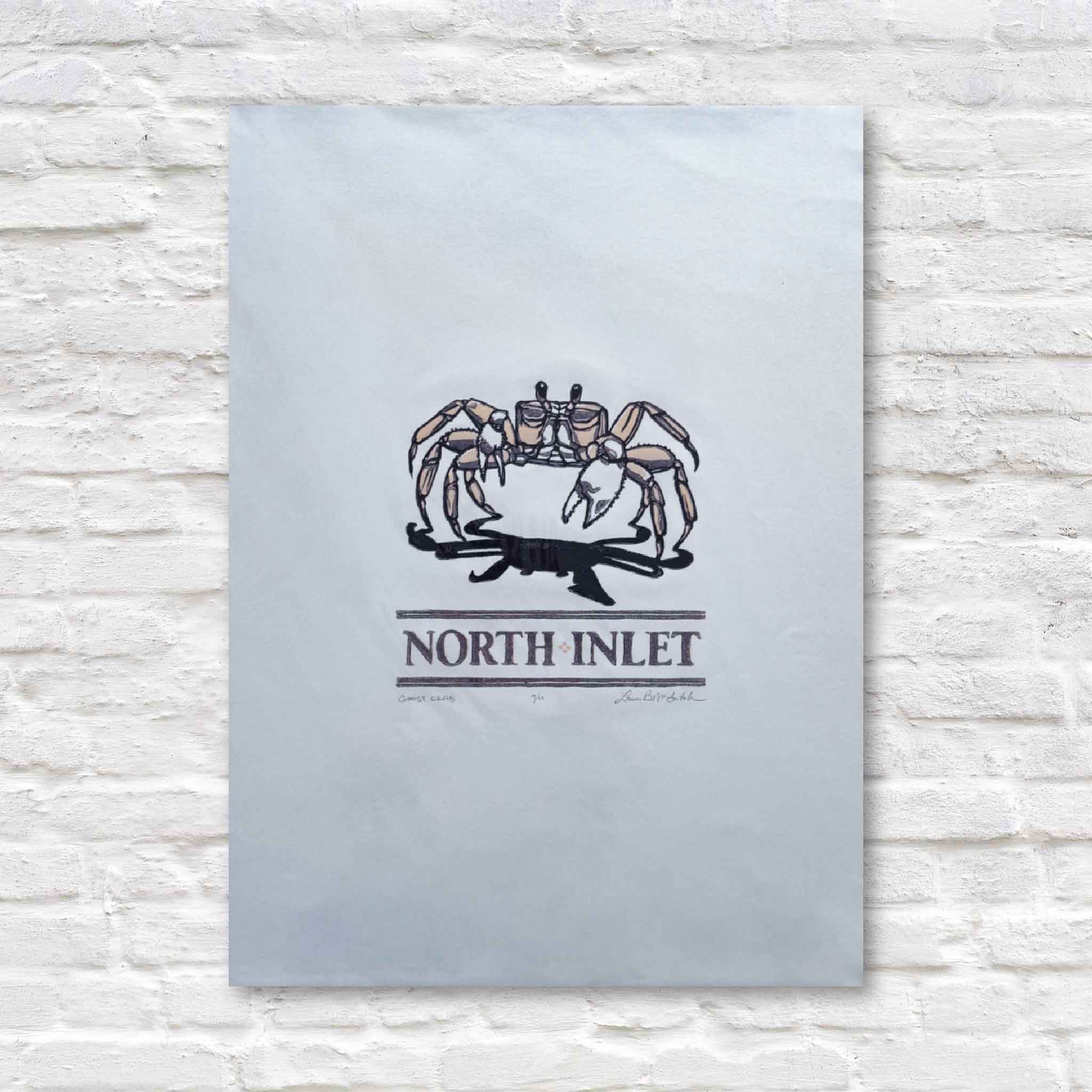 linocut artwork with crab design and 'North Inlet' text on a light wood background