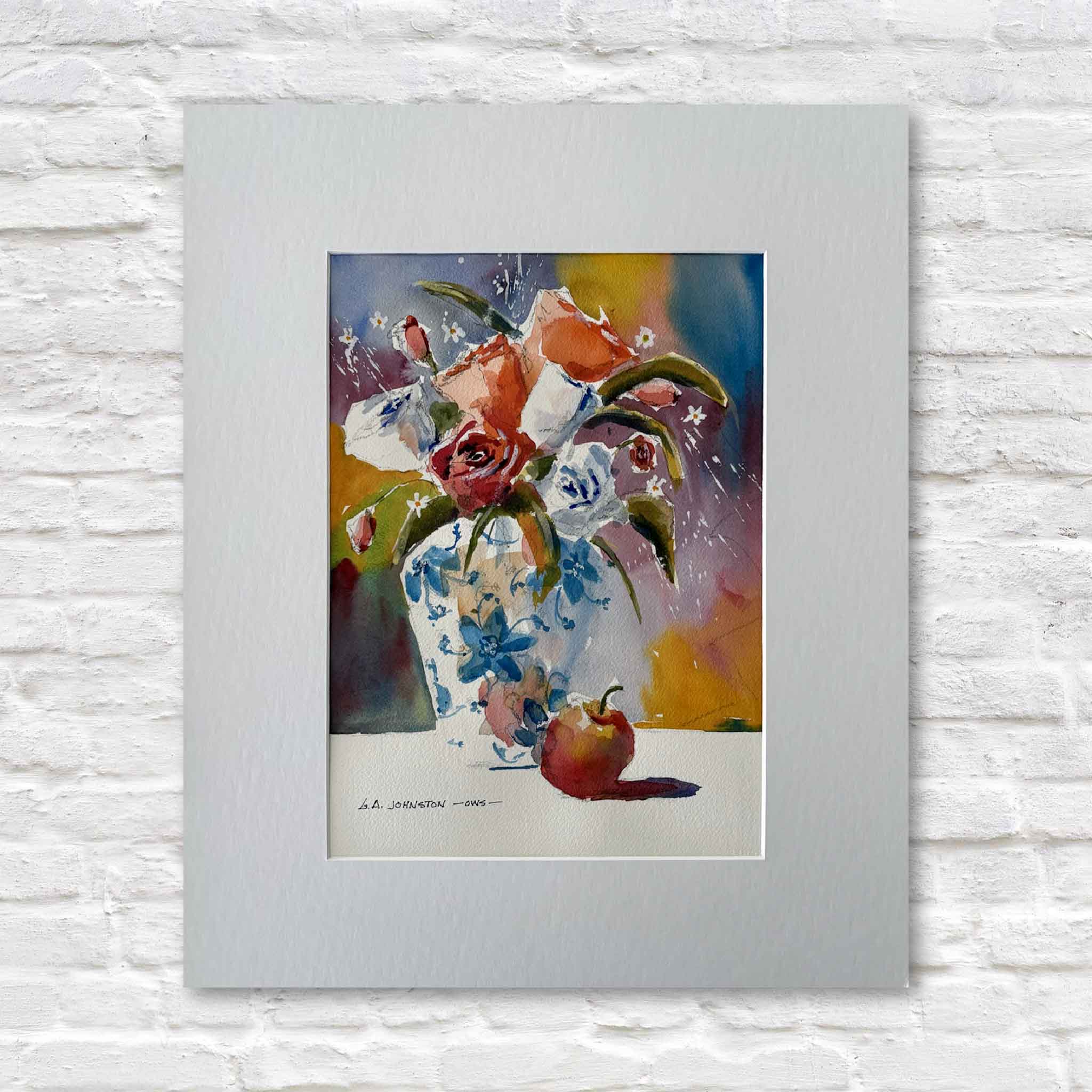 matted artwork of a floral still life with a vase and apple on a white brick wall.