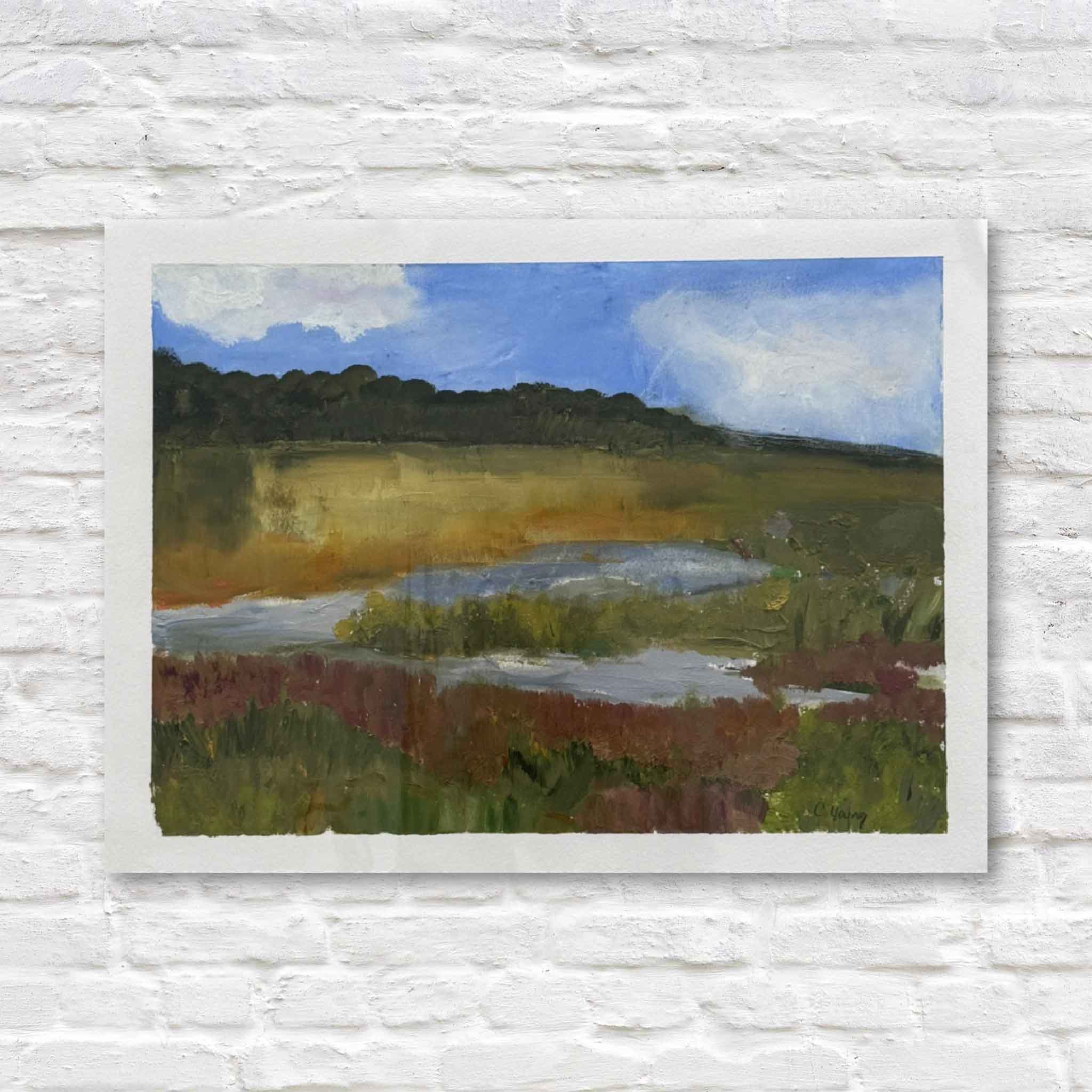 painting of a landscape with marsh and trees on a white brick wall.