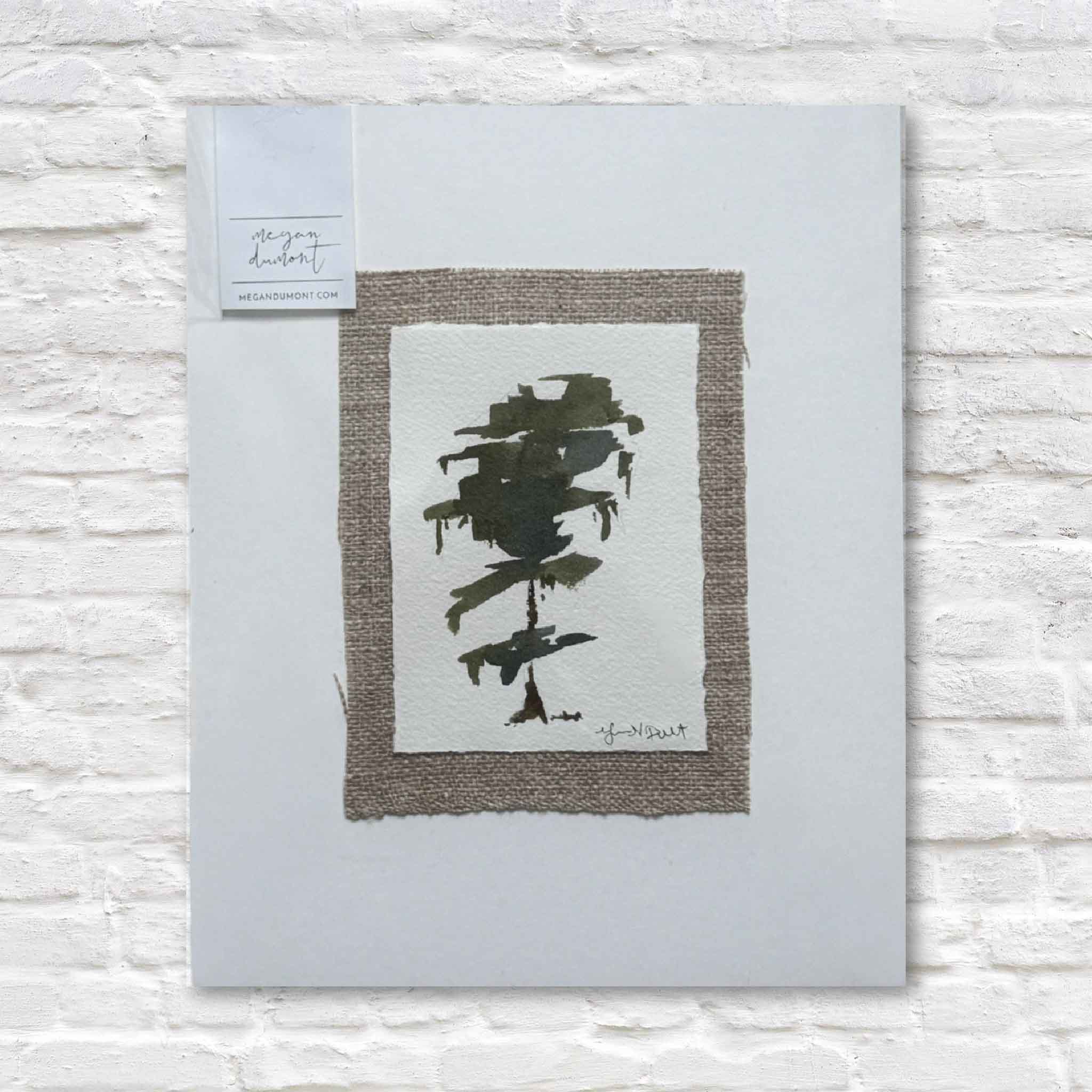 Abstract black art print on a textured gray background with a white label.
