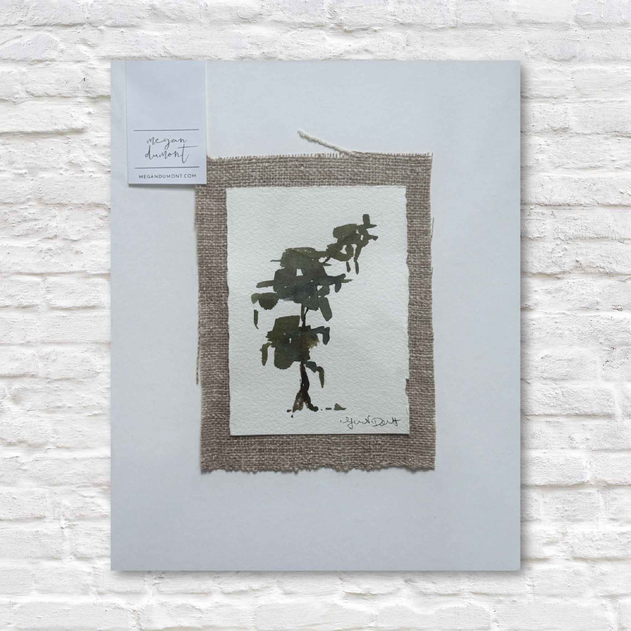 Framed abstract art print on a textured white surface