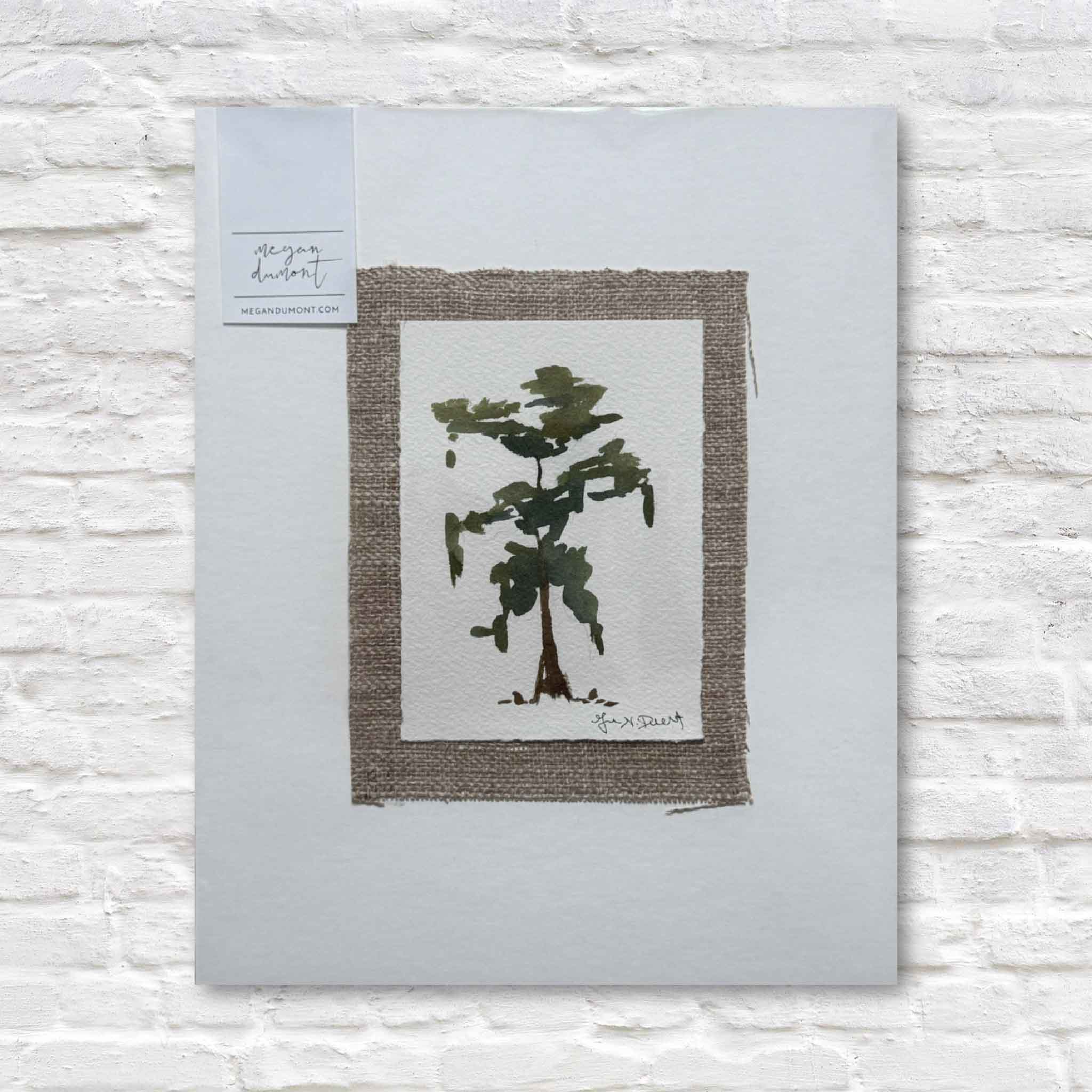 Framed artwork of a tree on a light gray background