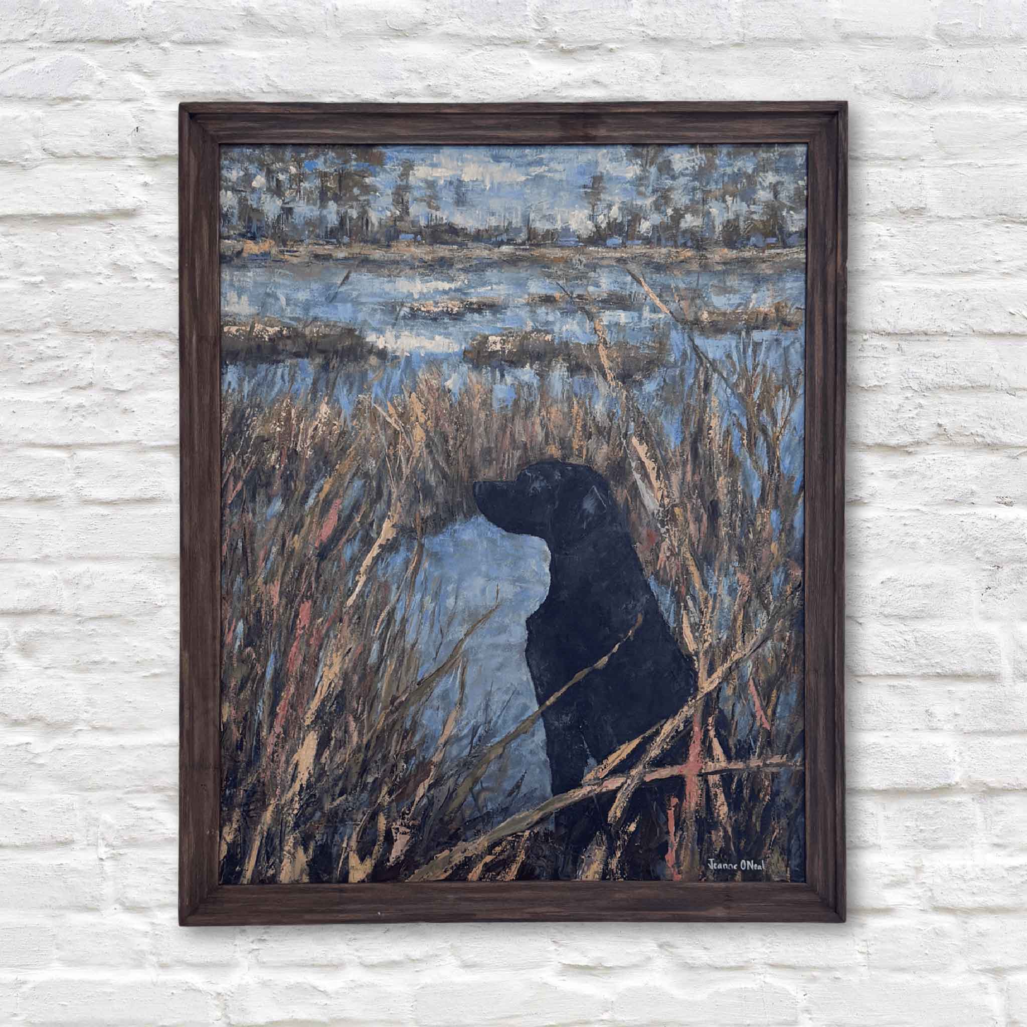 Framed painting of a black dog in reeds by a body of water on a textured white wall.