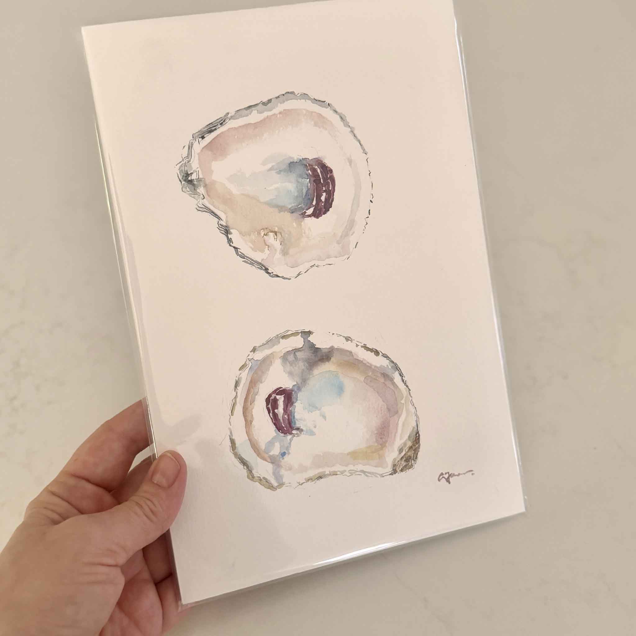 Hand-drawn and signed watercolor painting of two oyster shells with jewel-toned centers by artist Allison Farr, part of the Lowcountry Jewels series.