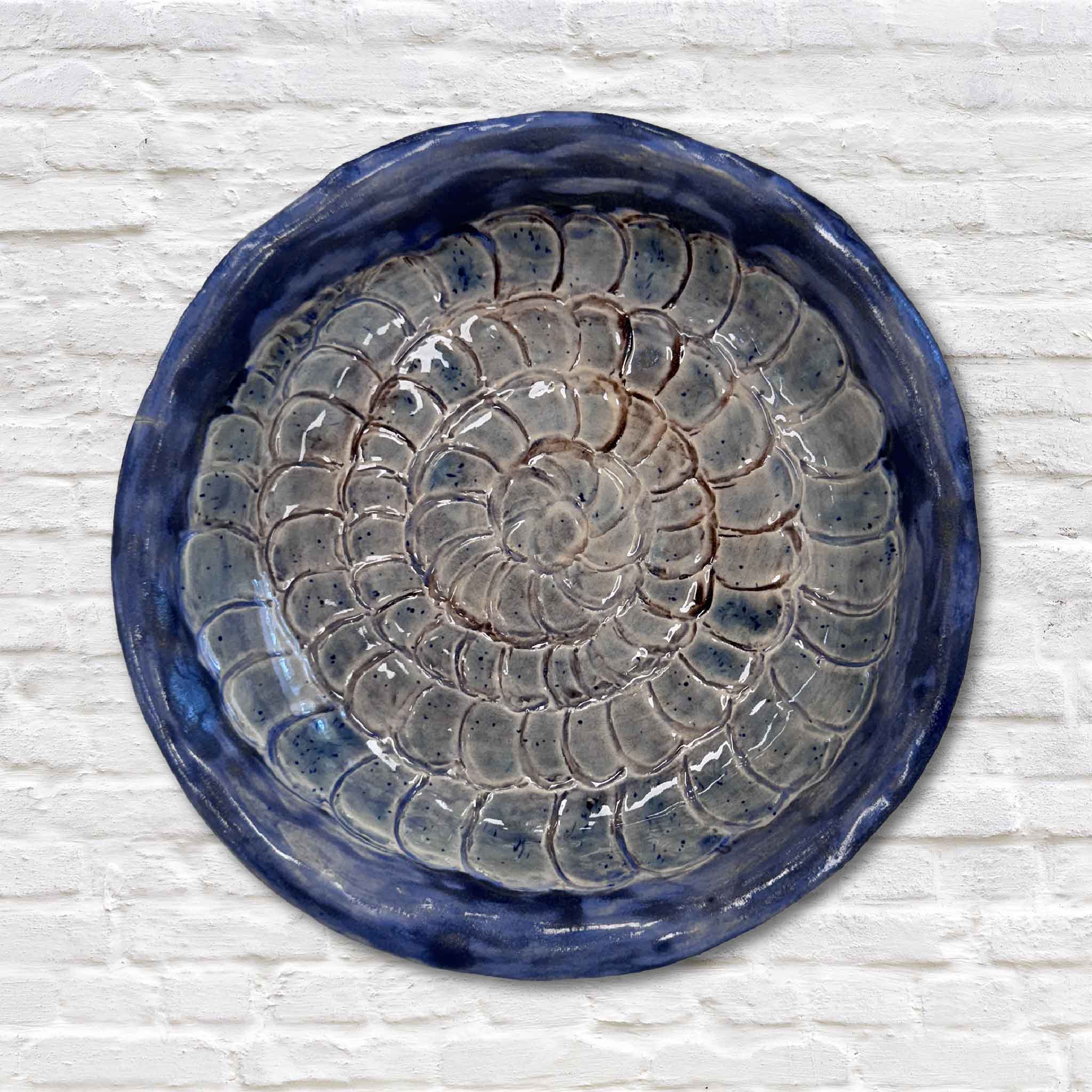coastal pottery on white brick wall