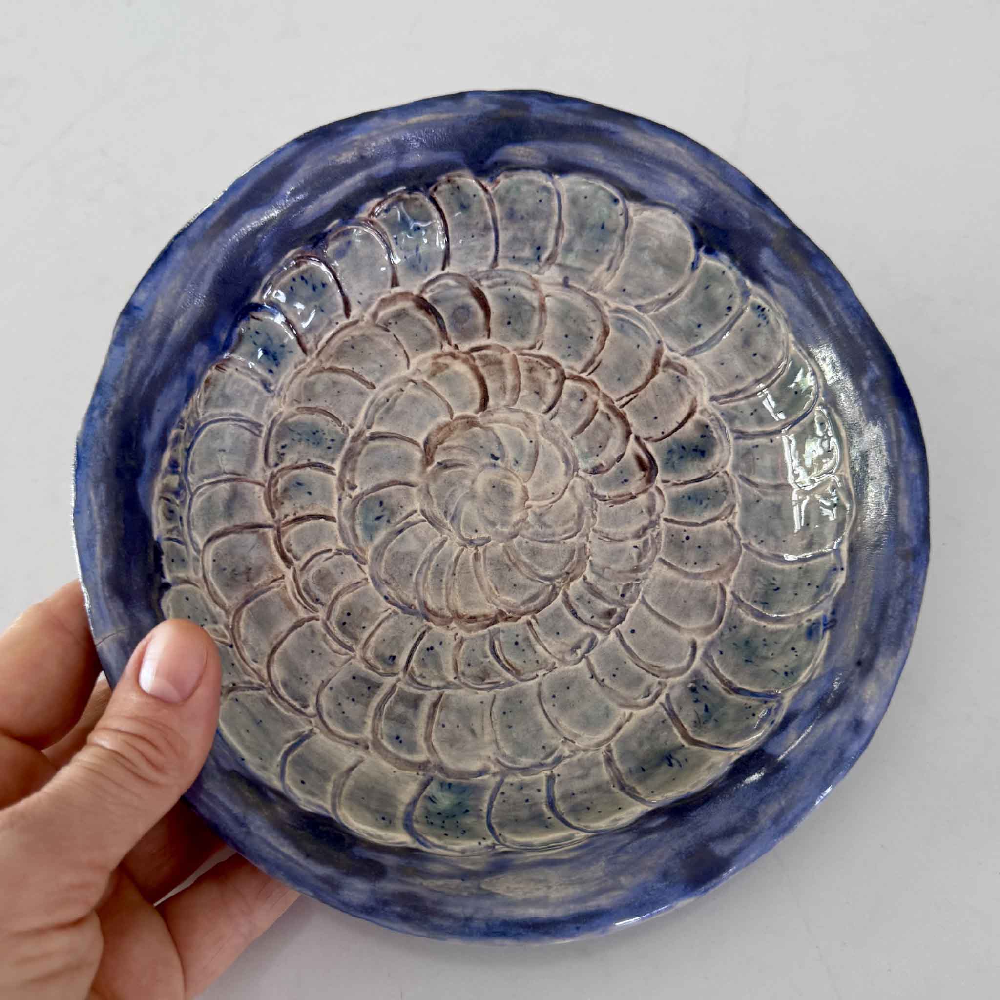 coastal blue pottery dish held in hand