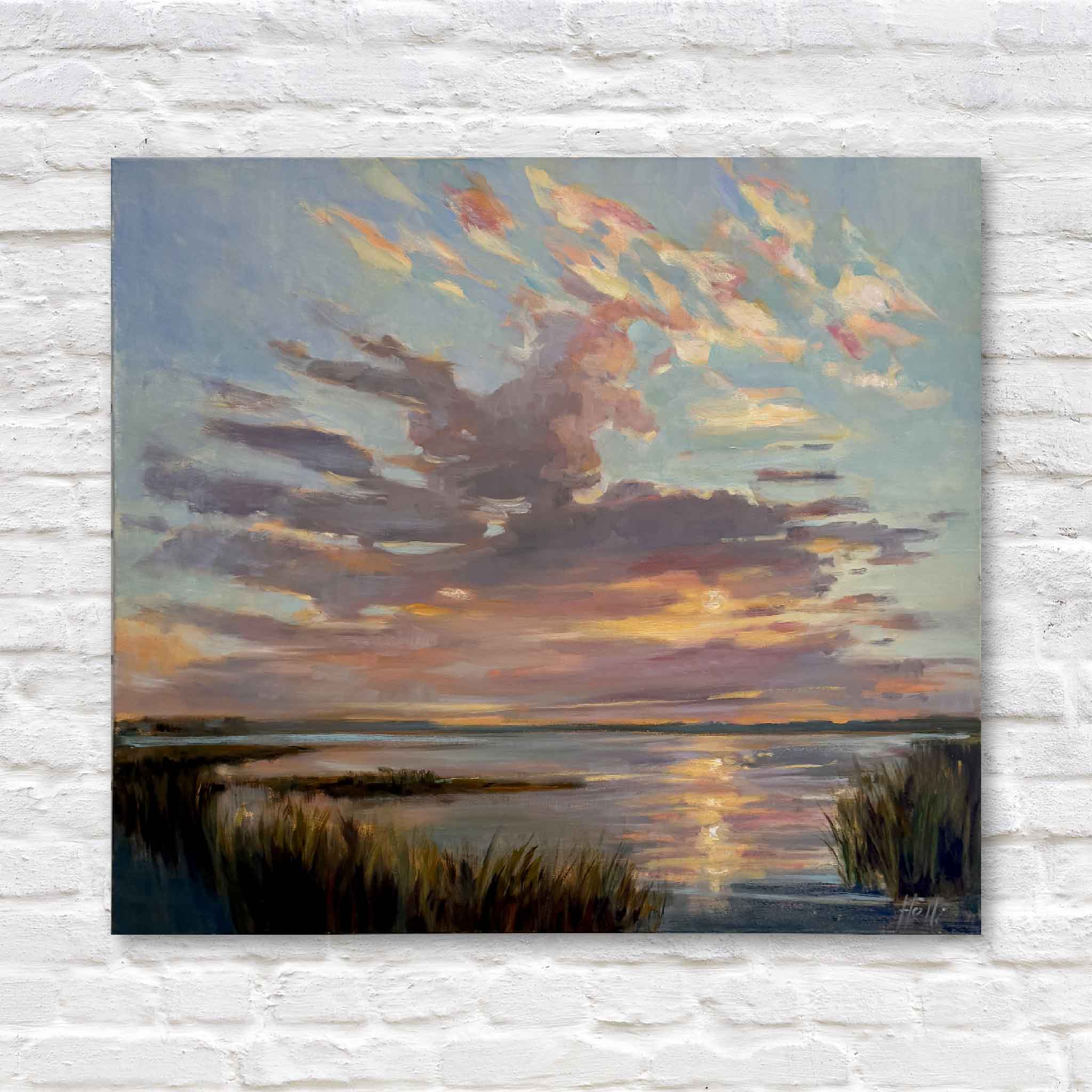 Oil painting of a sunset over a lowcountry marsh hanging on a white brick wall