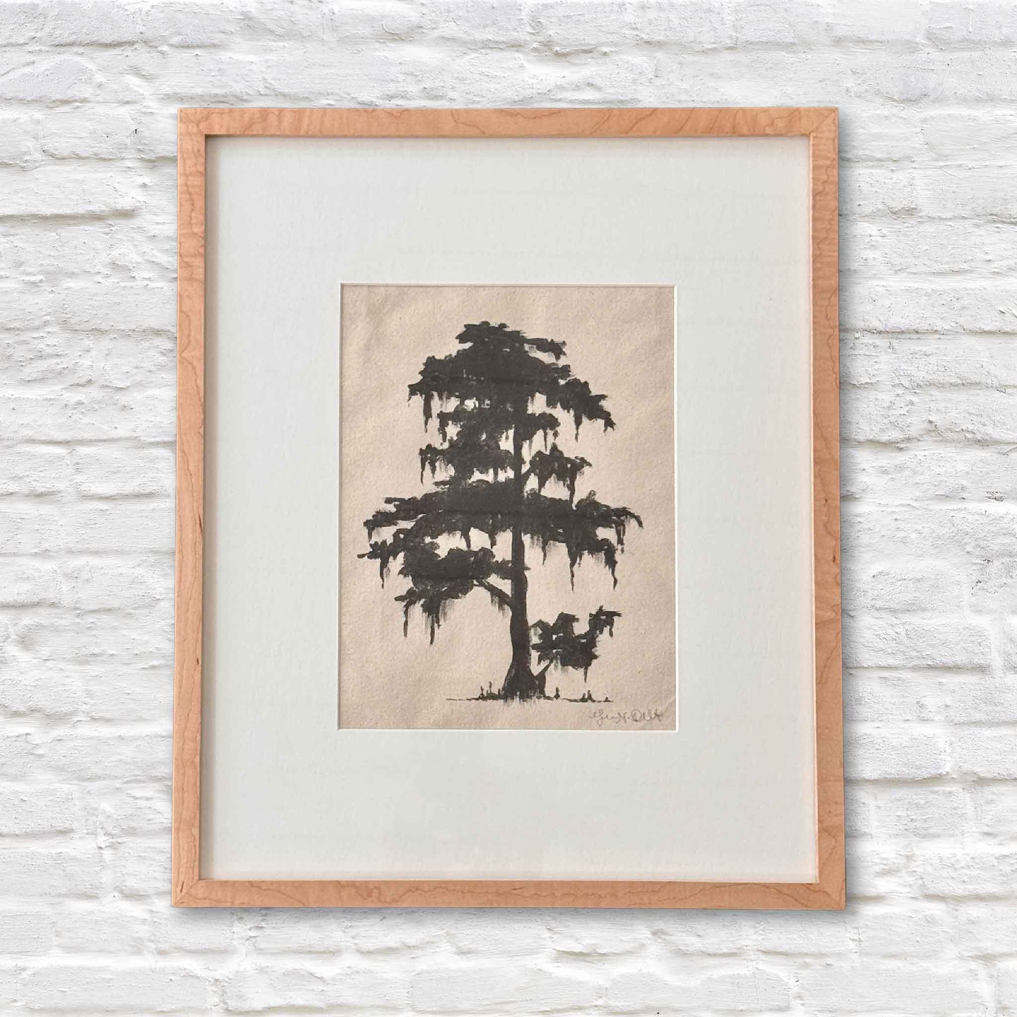 framed artwork of lowcountry tree in black ink on beige paper with a white matte on a white brick wall
