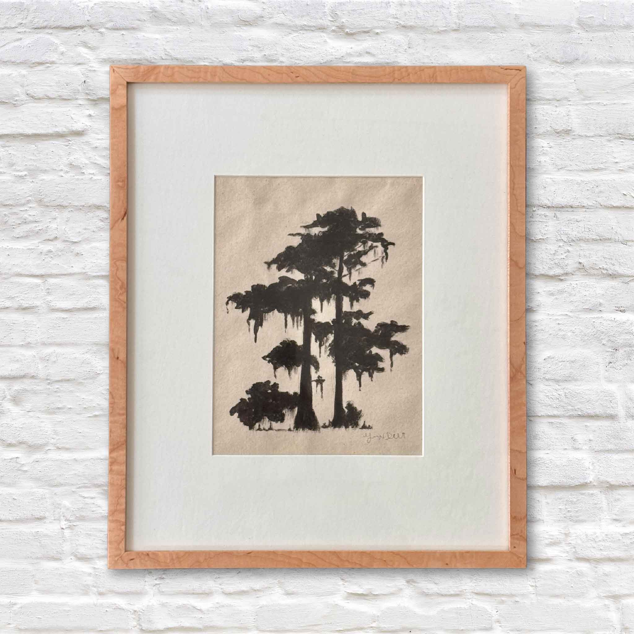 framed artwork of lowcountry tree in black ink on beige paper with a white matte on a white brick wall