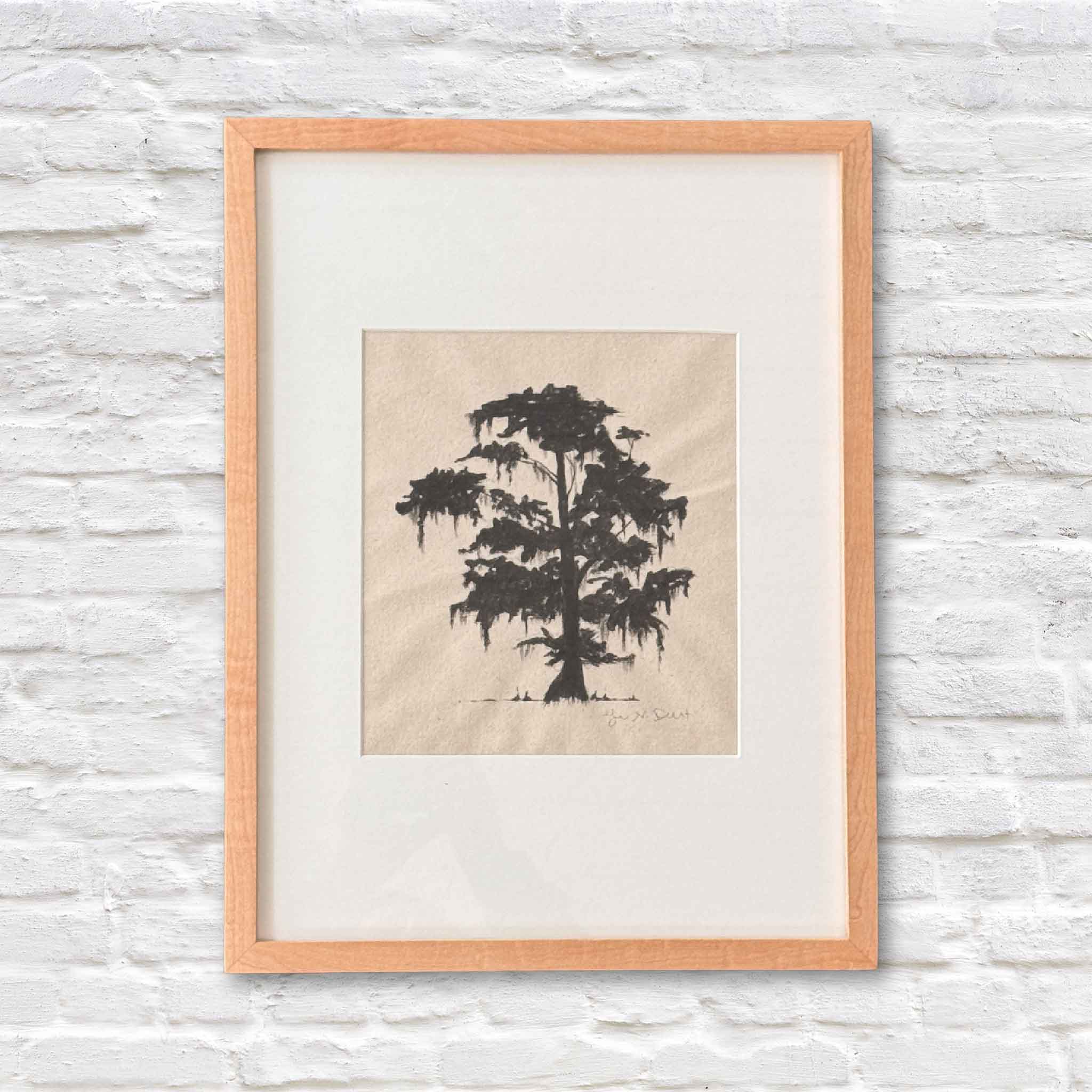 framed artwork of lowcountry tree in black ink on beige paper with a white matte on a white brick wall