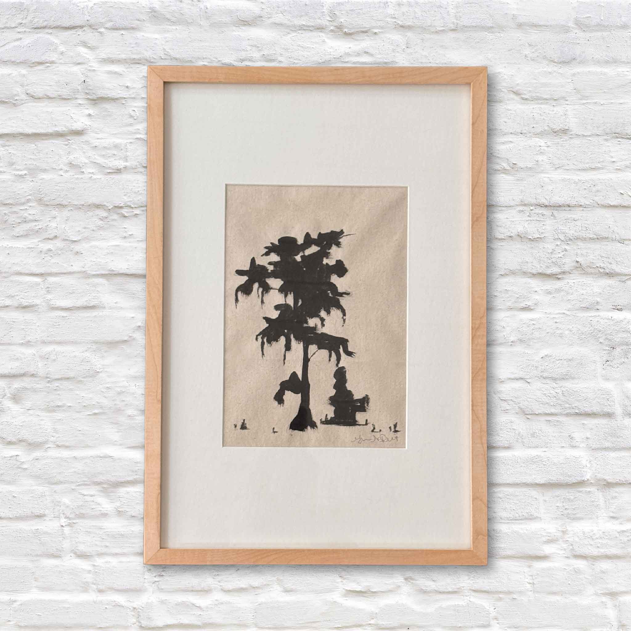 framed artwork of lowcountry tree in black ink on beige paper with a white matte on a white brick wall