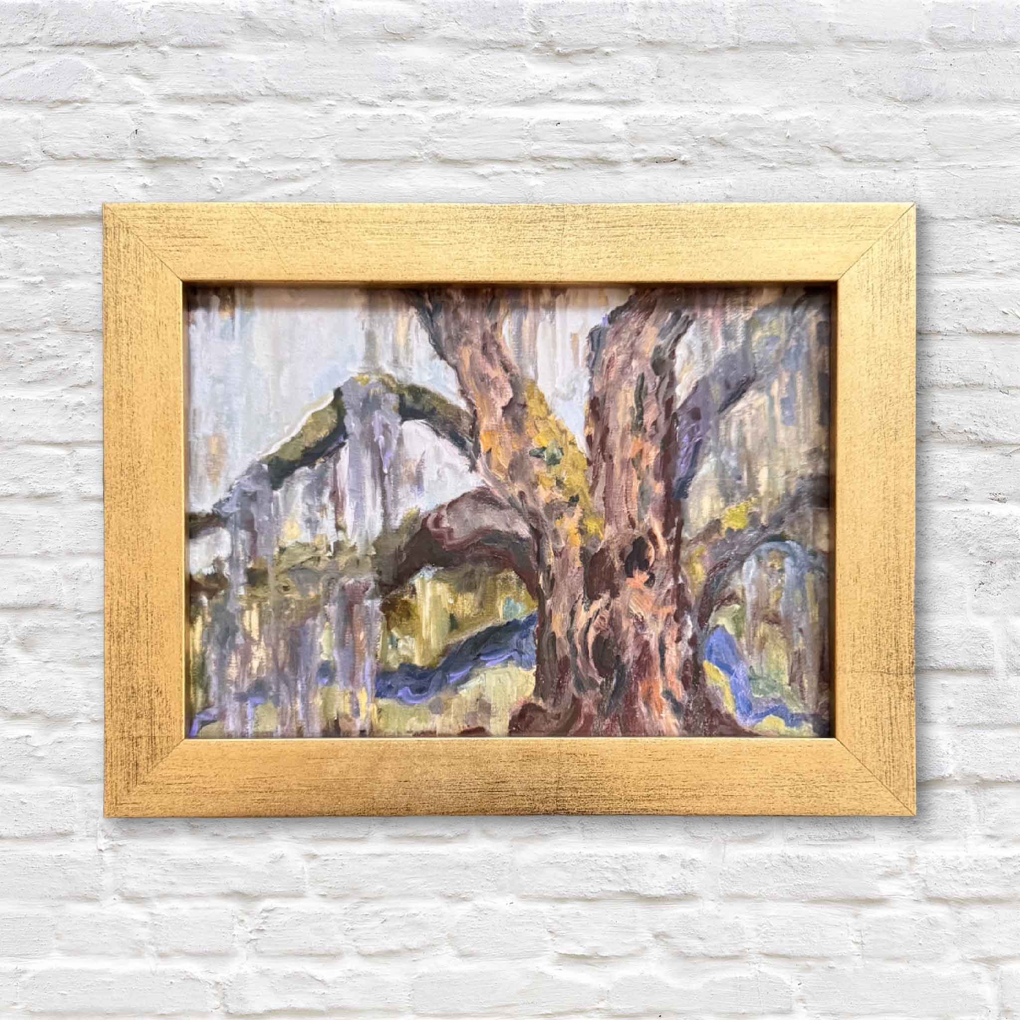 framed painting of lowcountry tree with spanish moss hanging on a white brick wall
