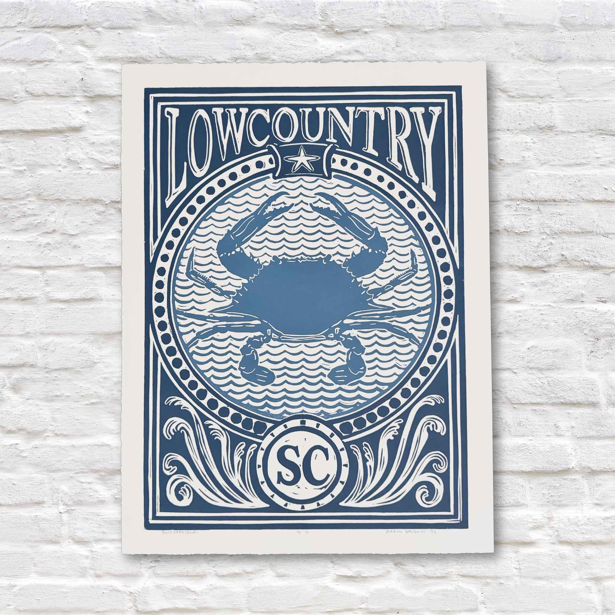 Blue linocut artwork of lowcountry blue crab on white brick background
