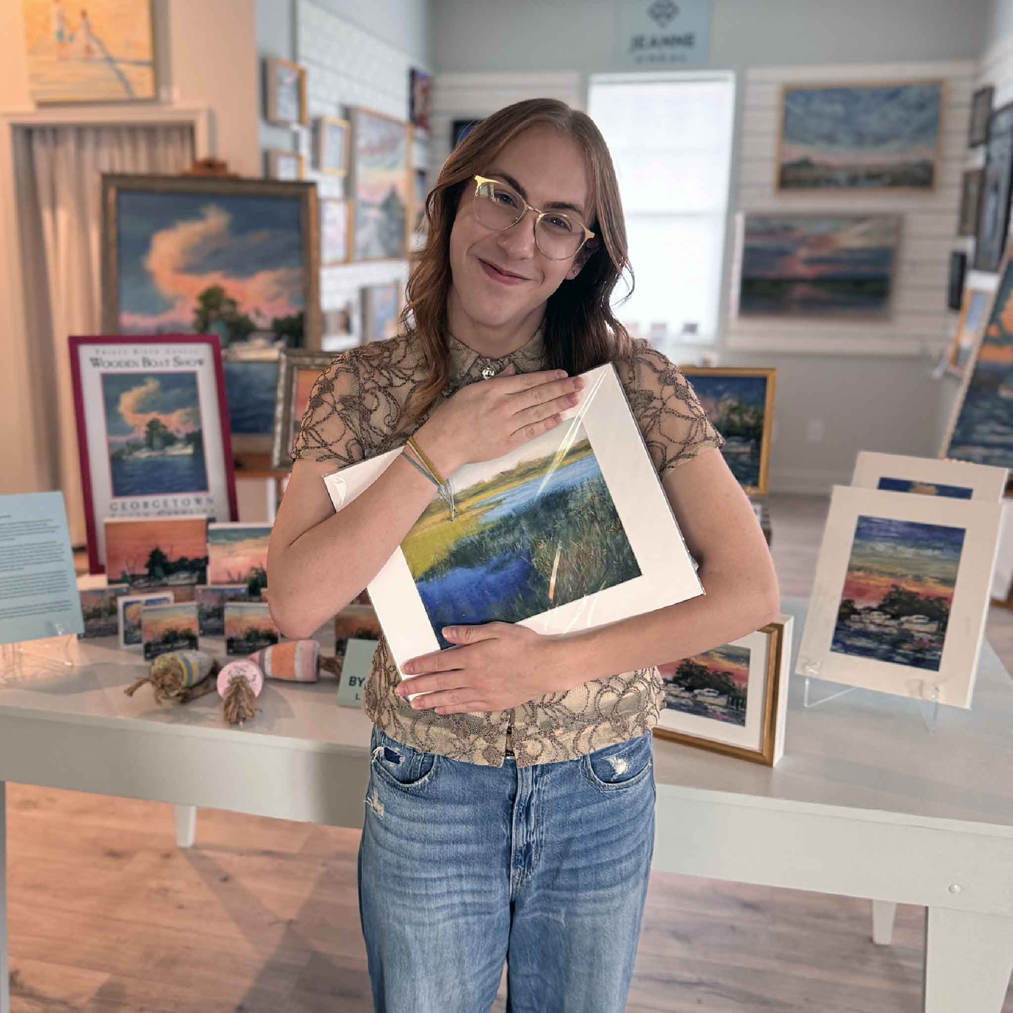 “Pawleys Blues” marsh art print by Joanne Willoughby, matted to 11×14, depicting blue tidal creek and green marsh grasses in soft pastel tones. Pictured at Gray Man Gallery