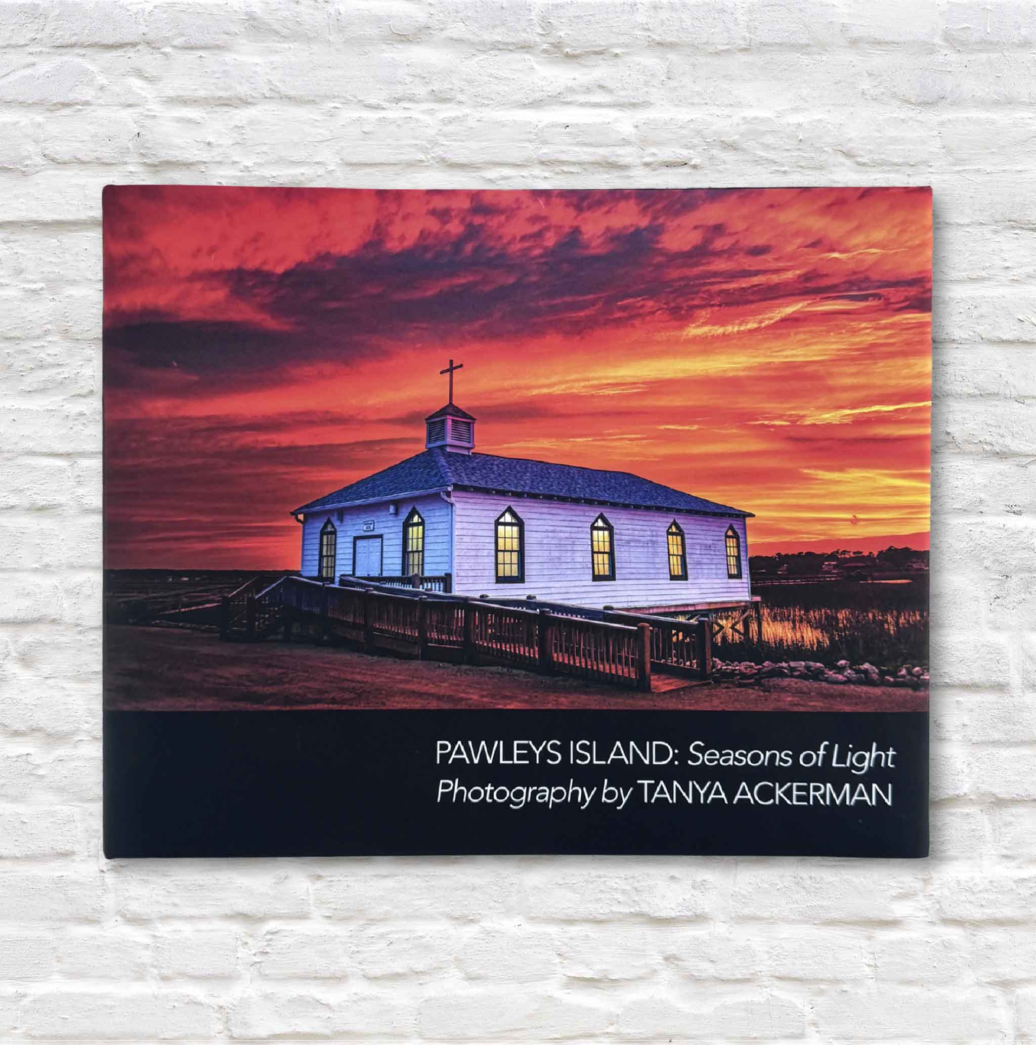 Front cover of Pawleys Island: Seasons of Light by Tanya Ackerman, Chapel Cover Edition, showing the Pawleys Island Chapel glowing at sunset under a vivid orange and red sky.