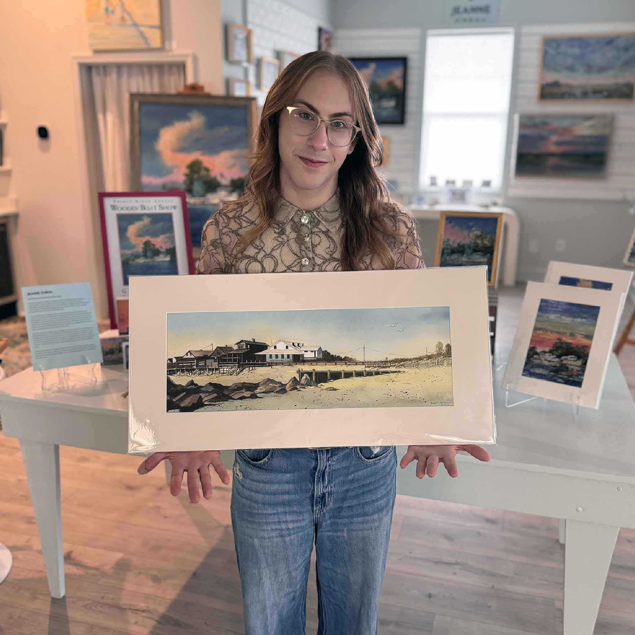 Original watercolor painting by Ralph Hollars showing historic Pawleys Island beachfront cottages, dunes, and shoreline in a panoramic coastal scene. Pictured at Gray Man Gallery.