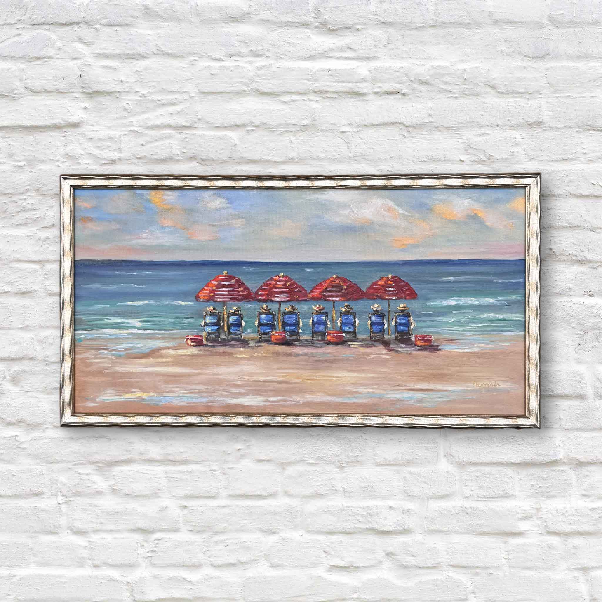 Framed oil painting “The Boardroom” by Jenny Reynolds featuring red beach umbrellas and blue chairs along the shoreline with ocean waves and clouds.
