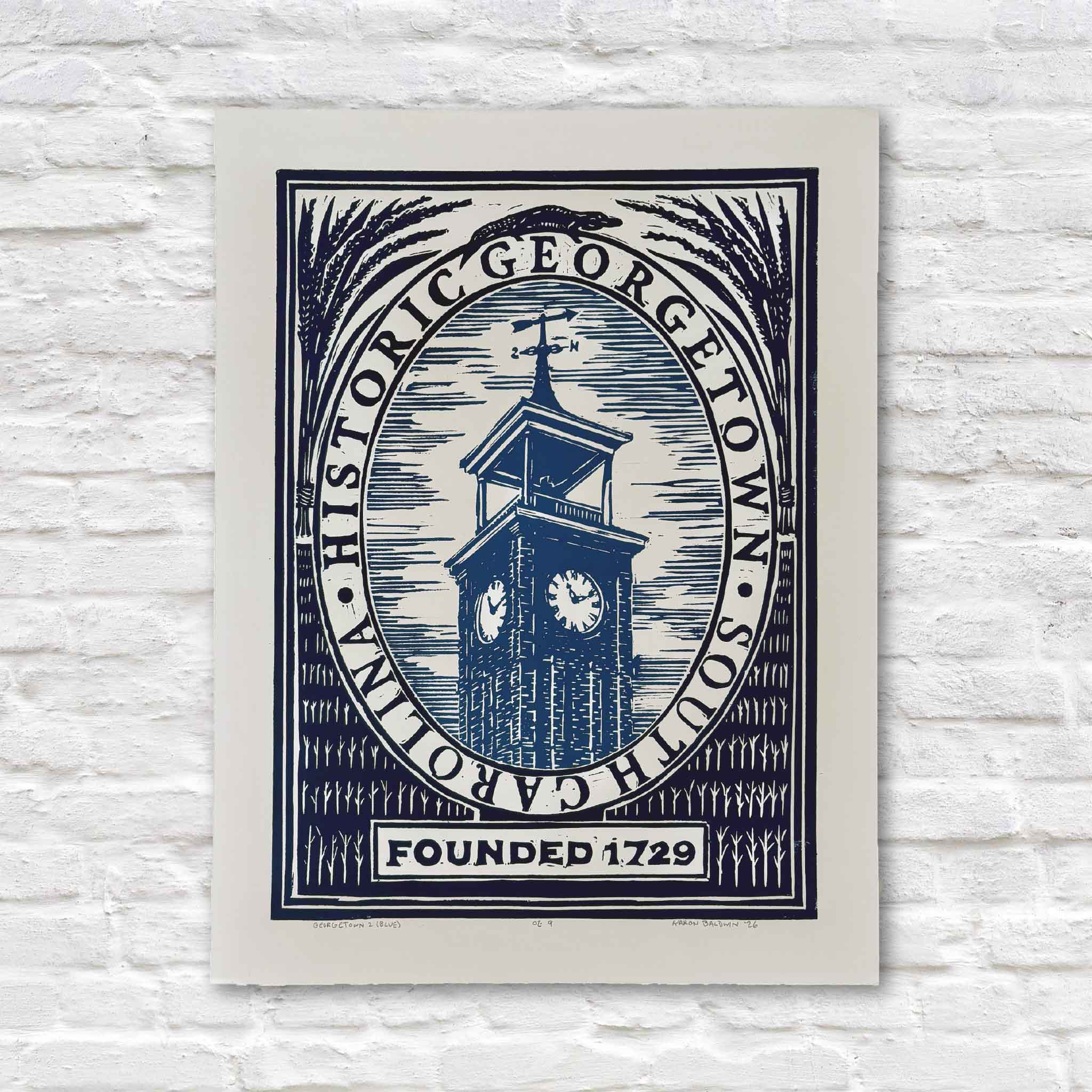 Georgetown by Aaron Baldwin, an original hand-pulled linocut featuring the historic Georgetown, South Carolina clock tower surrounded by a bold circular seal, with an alligator tucked across the top and “Founded 1729” below, available at Gray Man Gallery in Pawleys Island, South Carolina.