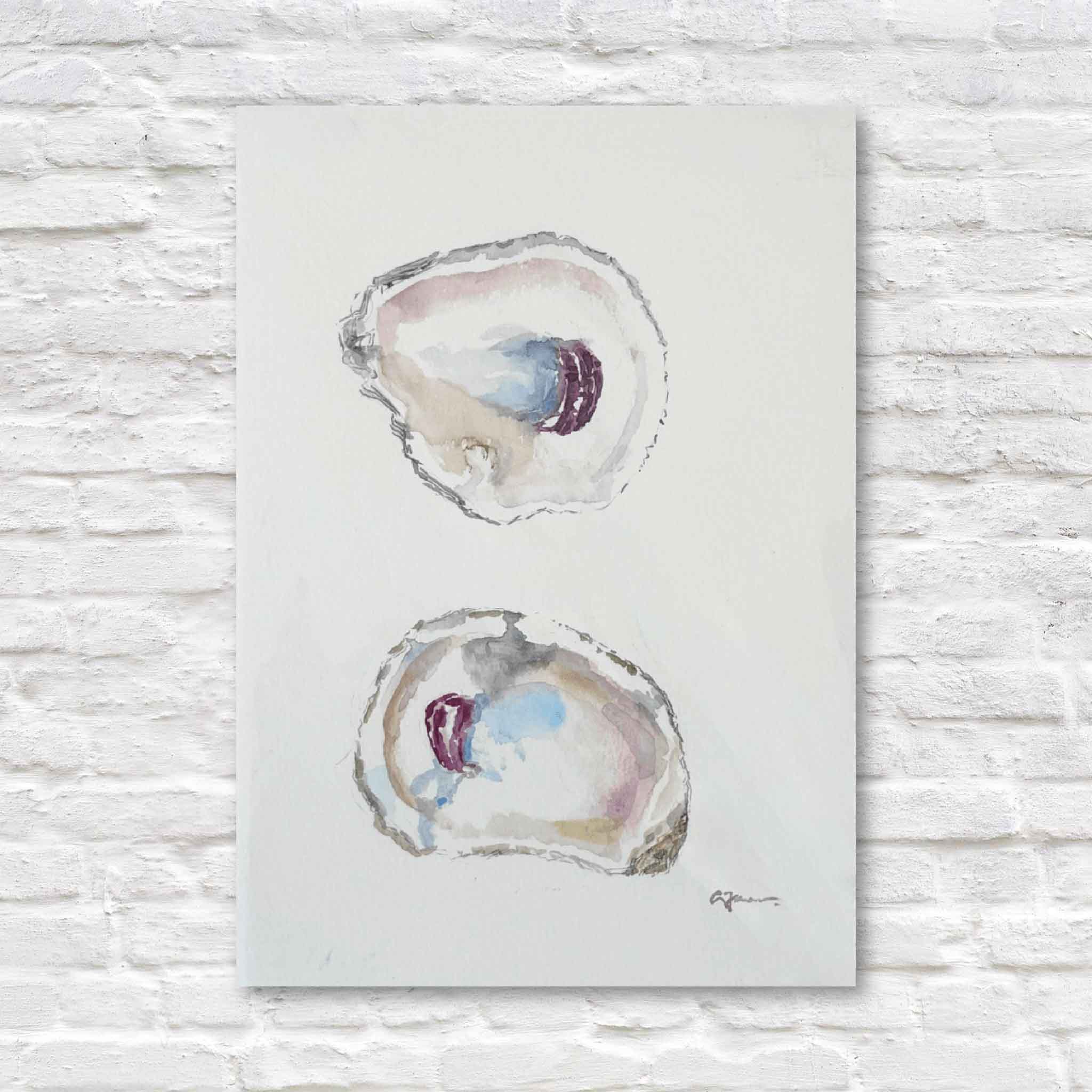Original watercolor painting “Surprise” by local Lowcountry artist Allison Farr featuring two oyster shells in soft coastal blues and blush tones, displayed at Gray Man Gallery in Pawleys Island, South Carolina