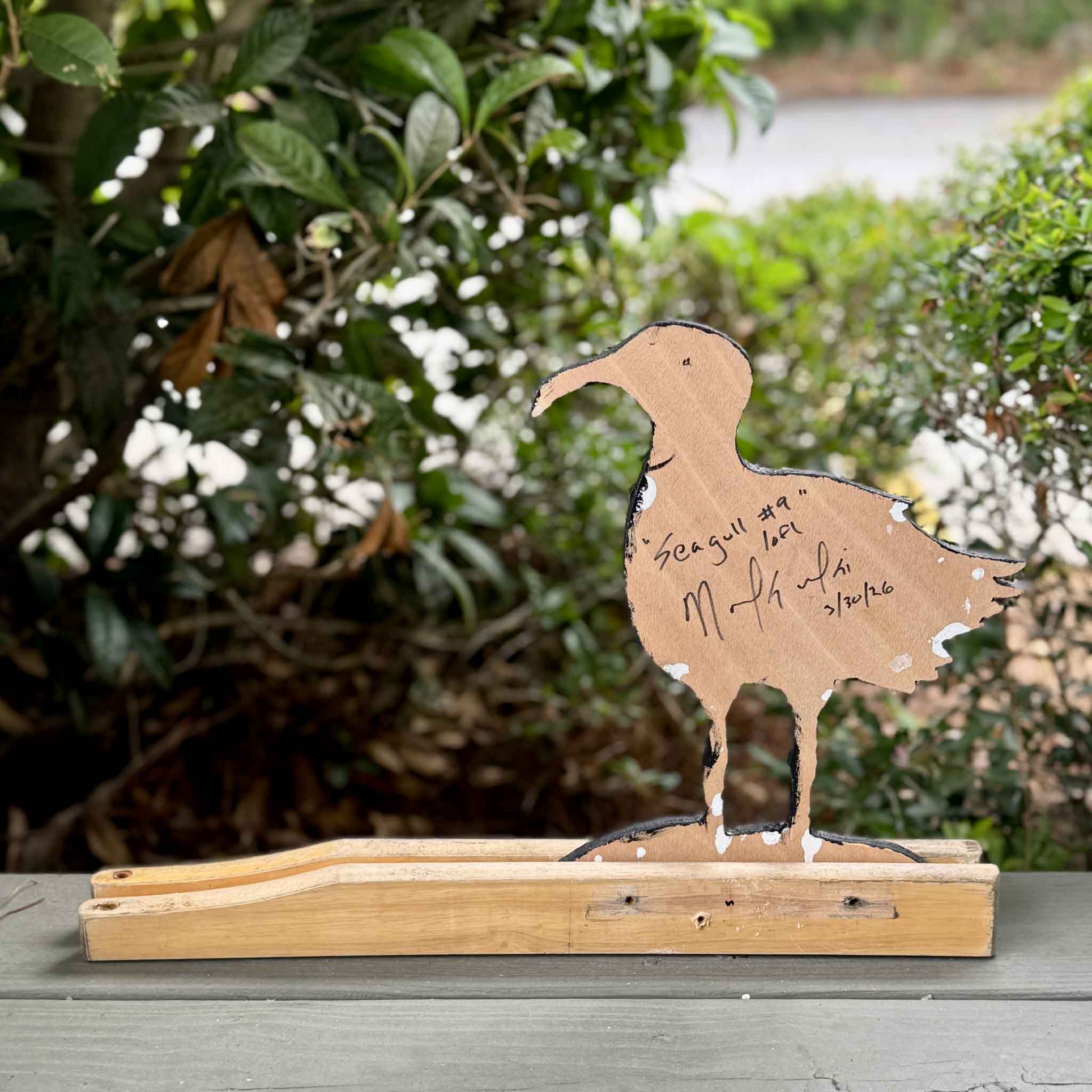 Back view of Seagull #9 by Nick Kawczynski showing the artist's signature, title, and edition information. This original coastal sculpture is handcrafted from reclaimed marine-grade plywood salvaged through the artist's volunteer work with the Lowcountry Maritime Society and is available at Gray Man Gallery in Pawleys Island, South Carolina.