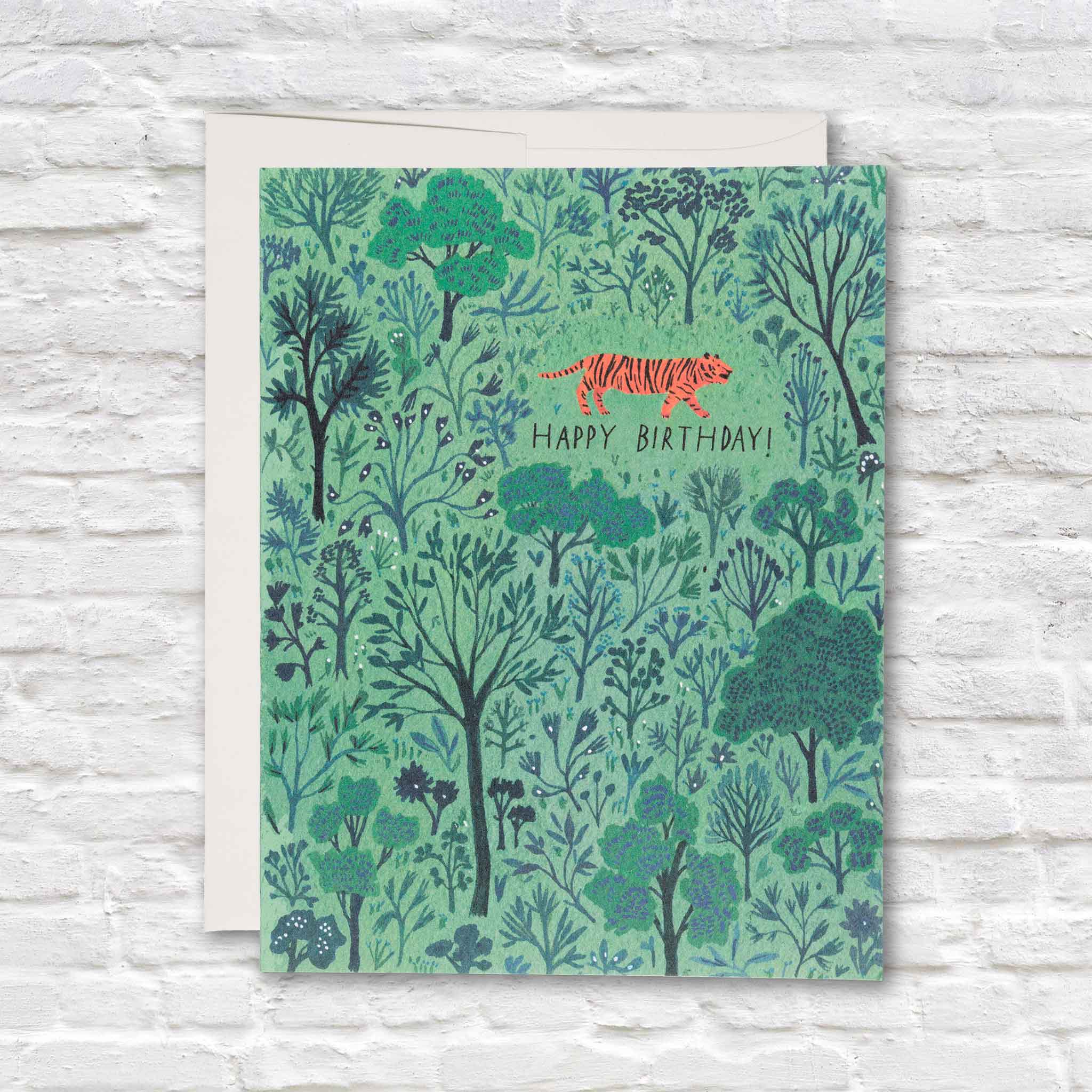 Orange Tiger Birthday greeting card by Becca Stadtlander for Red Cap Cards featuring a richly illustrated woodland landscape with a vibrant orange tiger and Happy Birthday message. Available at Gray Man Gallery in Pawleys Island, South Carolina, this premium blank-inside birthday card includes a matching envelope and is printed in the USA.