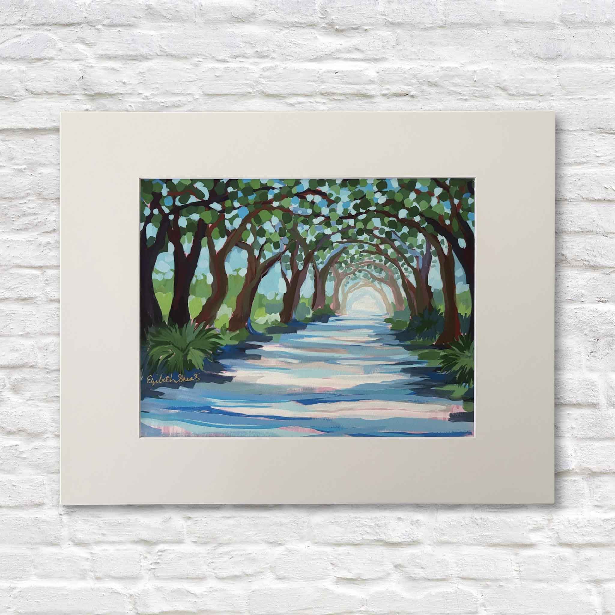 Elizabeth Sheats Beneath the Boughs Lowcountry landscape fine art giclée print on display at Gray Man Gallery in Pawleys Island SC, featuring oak-lined drive at Litchfield Plantation with live oaks, filtered sunlight, coastal South Carolina scenery, archival paper print matted for 11x14 and 16x20 frames