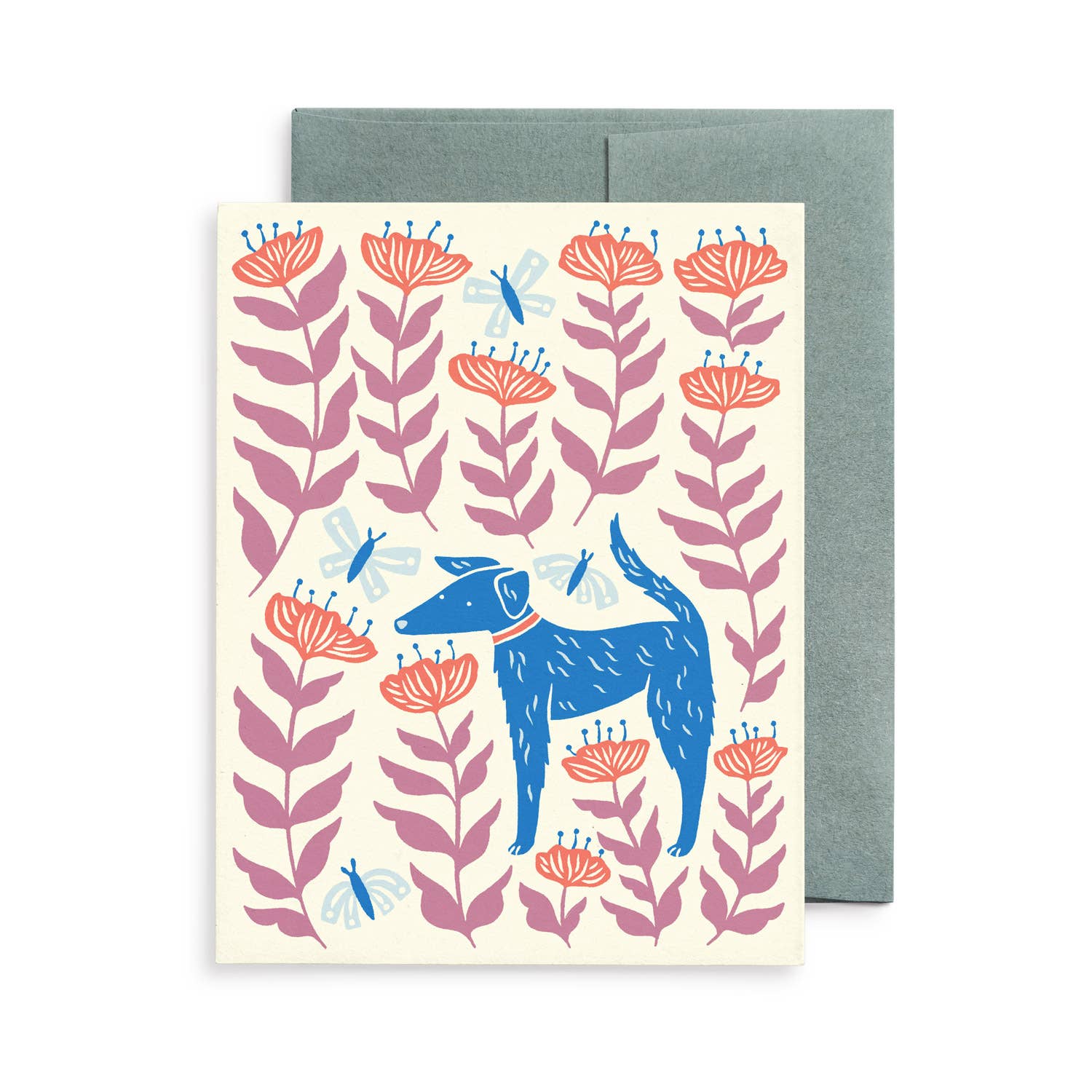 Blank greeting card featuring Chrissie Van Hoever's whimsical illustration of a blue dog standing among coral wildflowers, lavender foliage, and fluttering dragonflies. Printed on recycled paper with a matching kraft envelope and available at Gray Man Gallery in Pawleys Island, South Carolina.