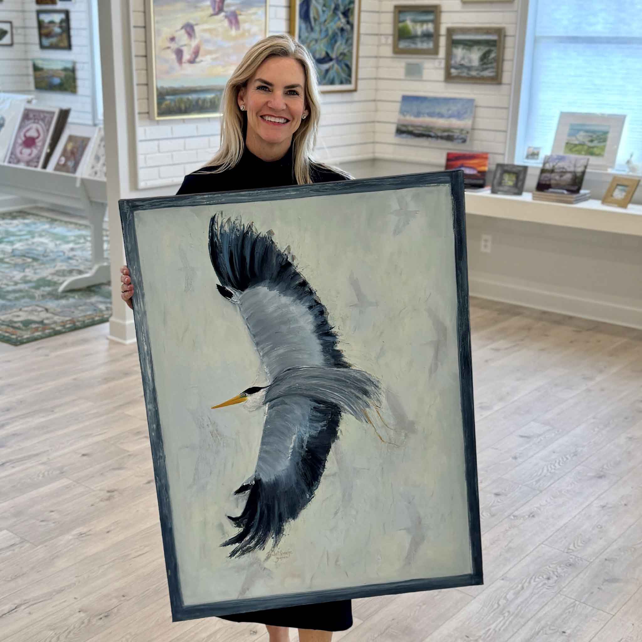 Local artist Braden Grafe Amen heron oil painting shown in Gray Man Gallery in Pawleys Island, gallery wrapped canvas with painted edge detail and expressive brushwork capturing a great blue heron in motion