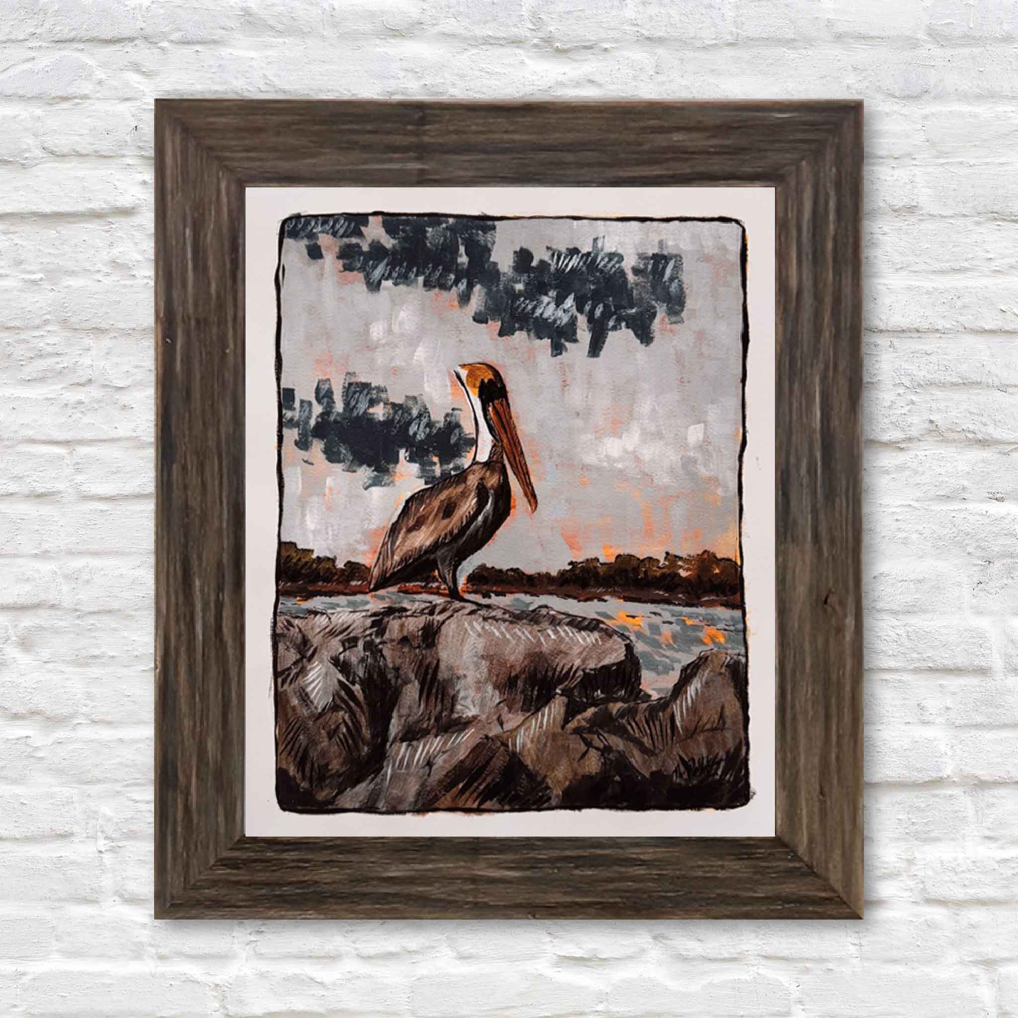 “Brown Pelican” fine art print by local Lowcountry artist Maggie Pelton displayed in a ready-made 16x20 frame from Gray Man Gallery in Pawleys Island, South Carolina, showing how this coastal wildlife artwork can be easily framed without custom framing and styled for home, office, or beach house décor
