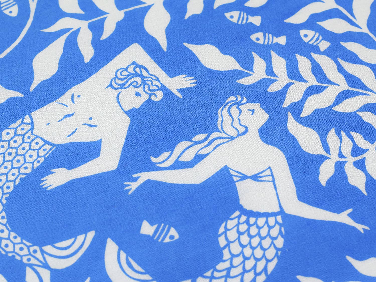 Close-up of the Cerulean Mermaid bandana featuring elegant mermaids swimming among kelp fronds in a detailed coastal illustration by Chrissie Van Hoever, sold at Gray Man Gallery in Pawleys Island, South Carolina.
