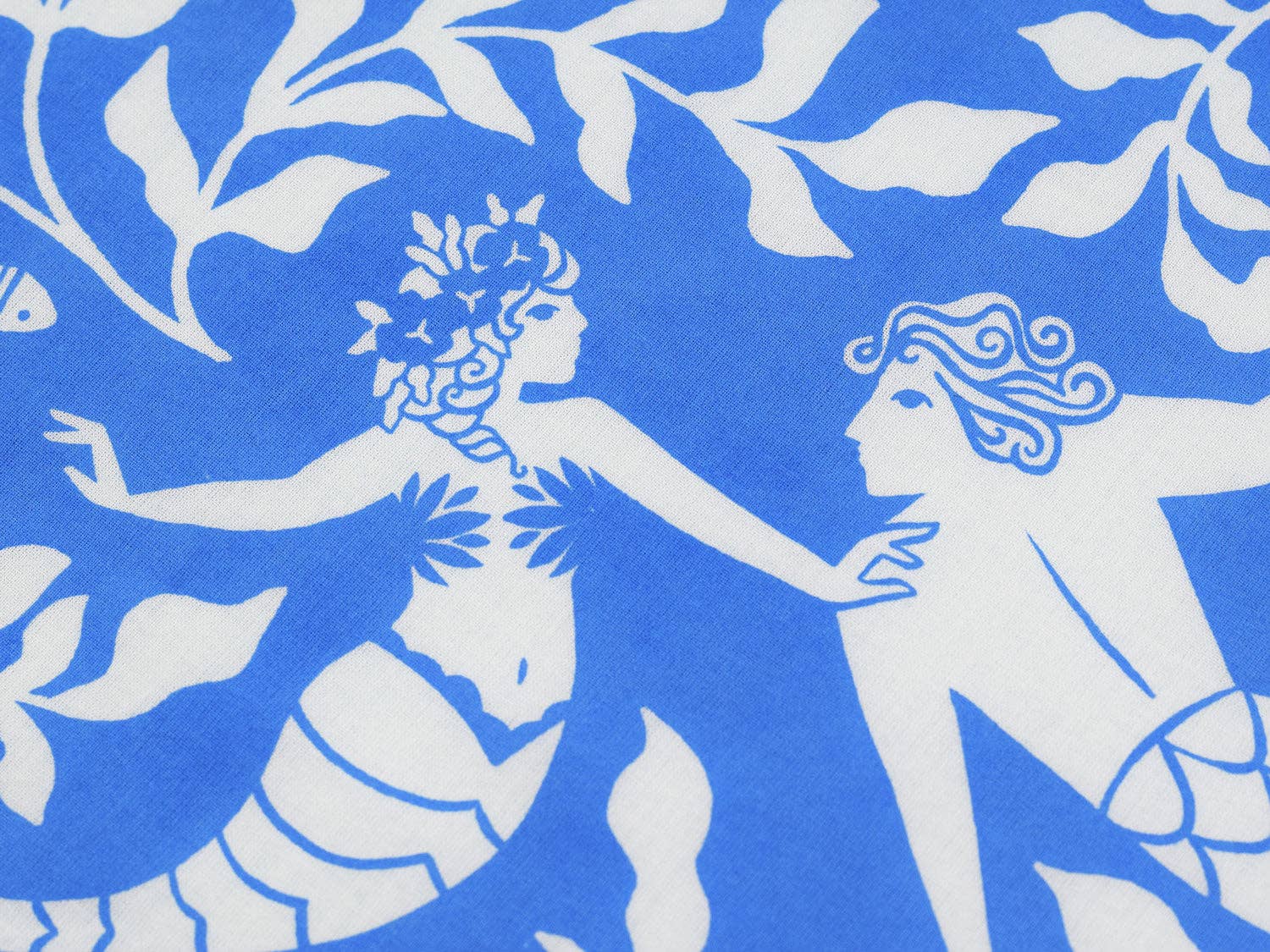 Close-up of the Cerulean Mermaid organic cotton bandana by Chrissie Van Hoever showing two beautifully illustrated mermaids surrounded by flowing kelp and small fish on vibrant cerulean blue fabric, available at Gray Man Gallery in Pawleys Island.
