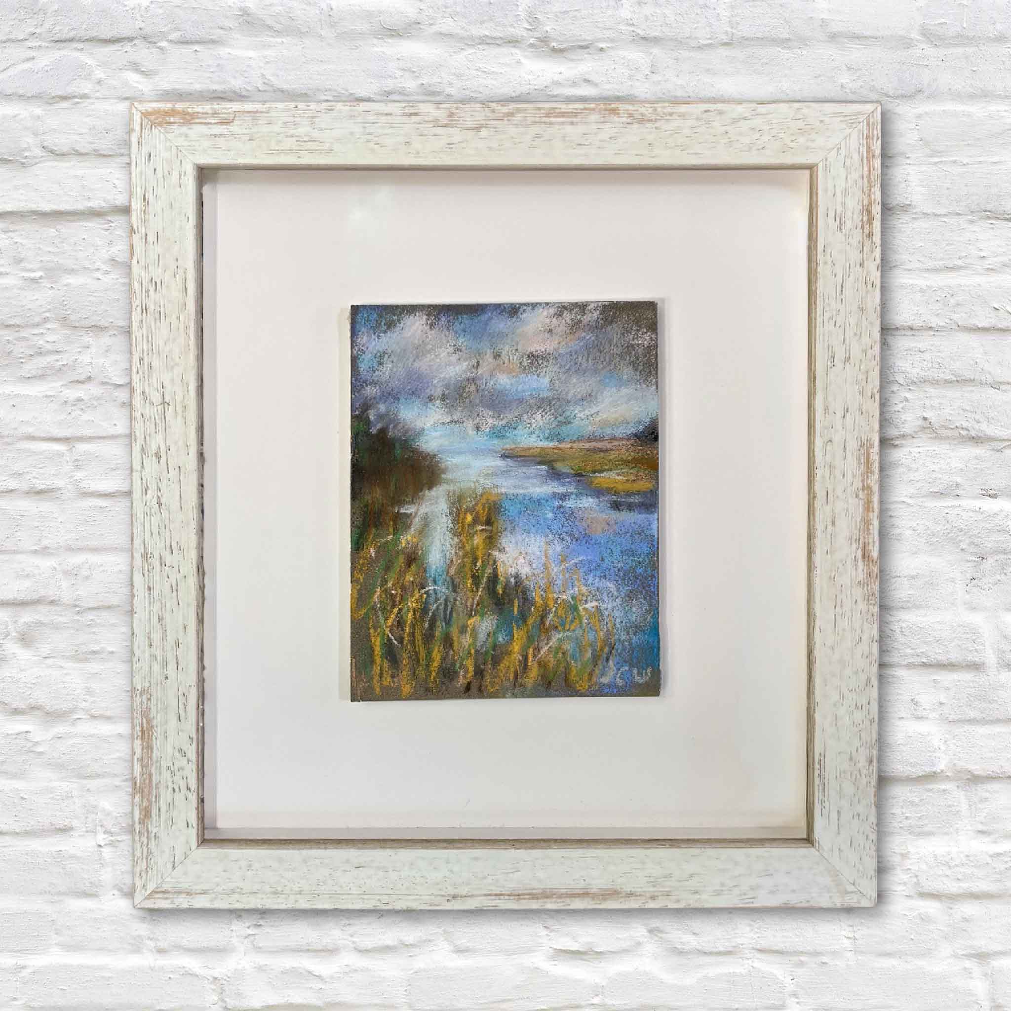 Chance of Rain by Joanne Willoughby is an original pastel depicting a peaceful Lowcountry marsh with reflective tidal water, marsh grasses, and dramatic clouds. Professionally matted and custom framed with premium Water White glass at Gray Man Gallery in Pawleys Island, South Carolina, this one-of-a-kind landscape beautifully captures the changing light and quiet beauty of the South Carolina coast.