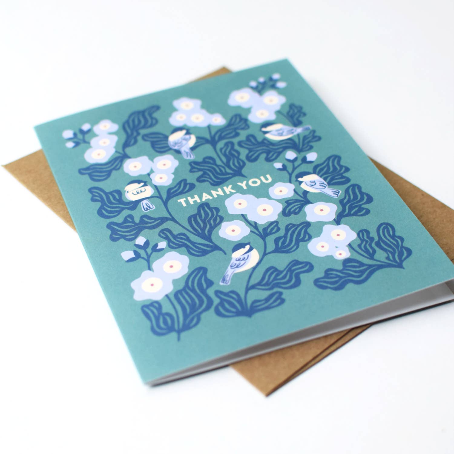 Open view of the Chickadee Thank You greeting card by Chrissie Van Hoever displayed with its recycled kraft envelope, showcasing the premium uncoated recycled cardstock and charming bird illustration available at Gray Man Gallery in Pawleys Island, South Carolina.