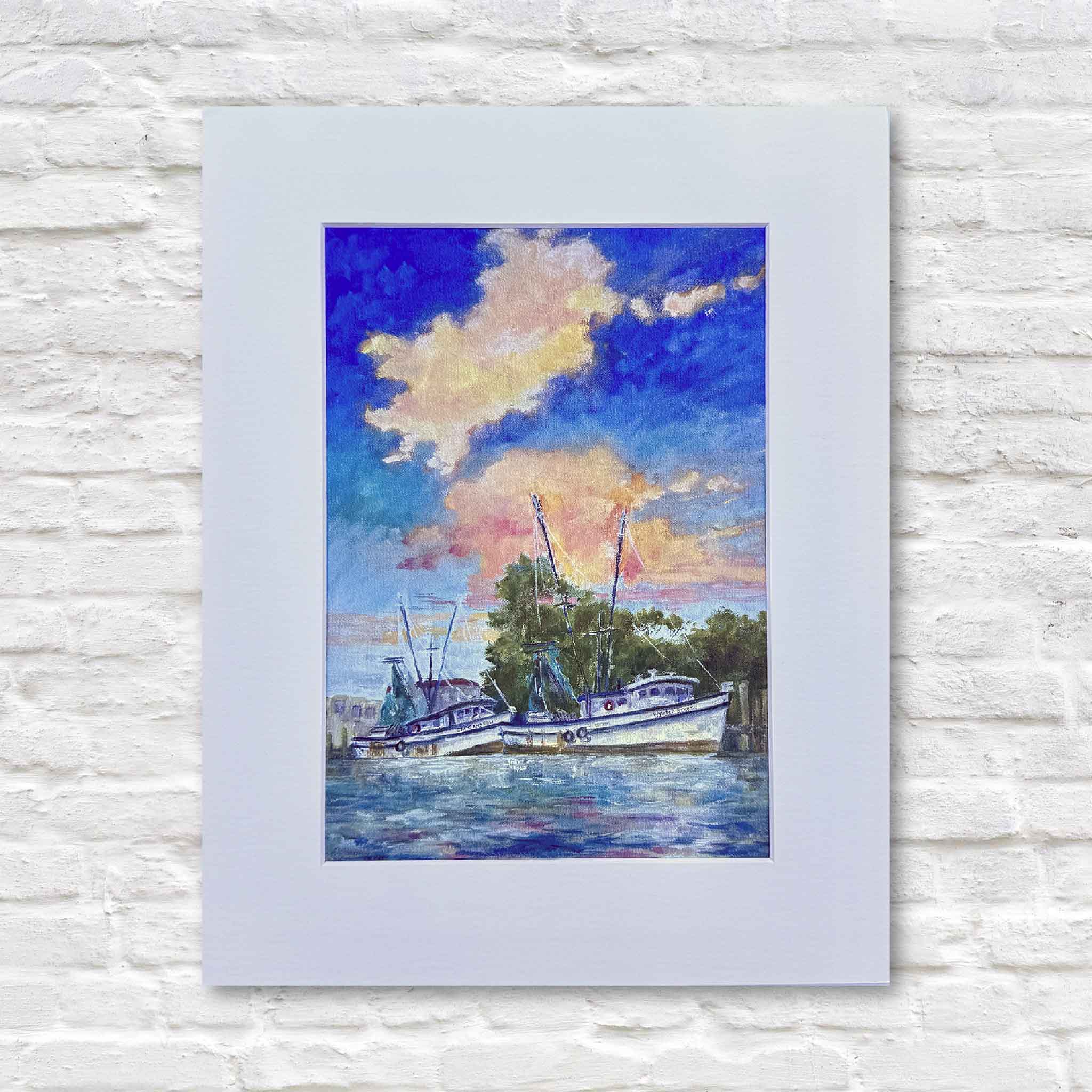 Original giclée print “Day’s End” by Jeanne O’Neal featuring shrimp boats at sunset in Georgetown harbor, professionally matted and framed, photographed at Gray Man Gallery in Pawleys Island, South Carolina, Lowcountry coastal art