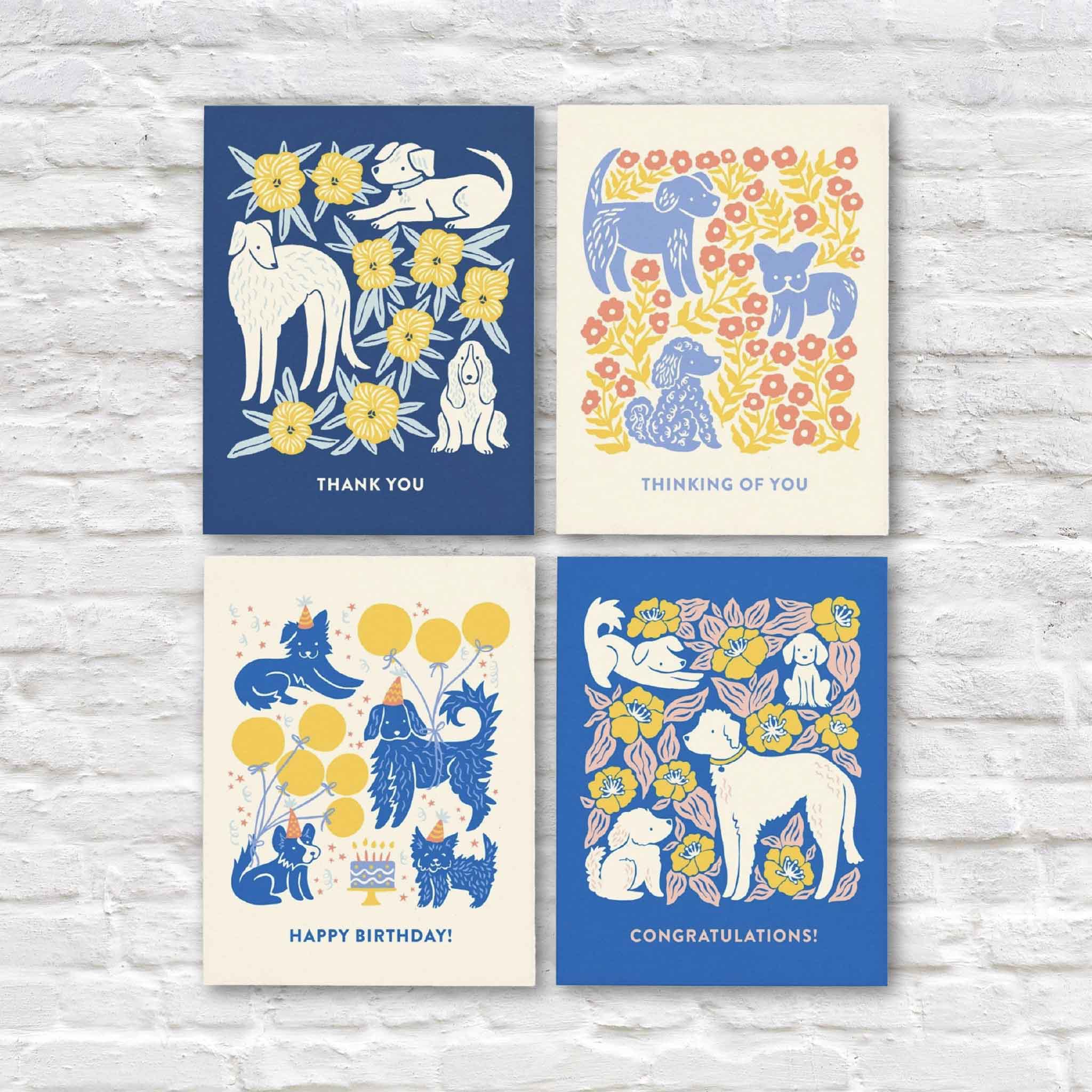 Dogs All-Occasion Greeting Card Boxed Set by Chrissie Van Hoever at Gray Man Gallery in Pawleys Island, South Carolina. This boxed collection includes eight eco-friendly blank greeting cards featuring whimsical dog and floral illustrations with thank you, thinking of you, happy birthday, and congratulations designs, complete with matching recycled kraft envelopes.