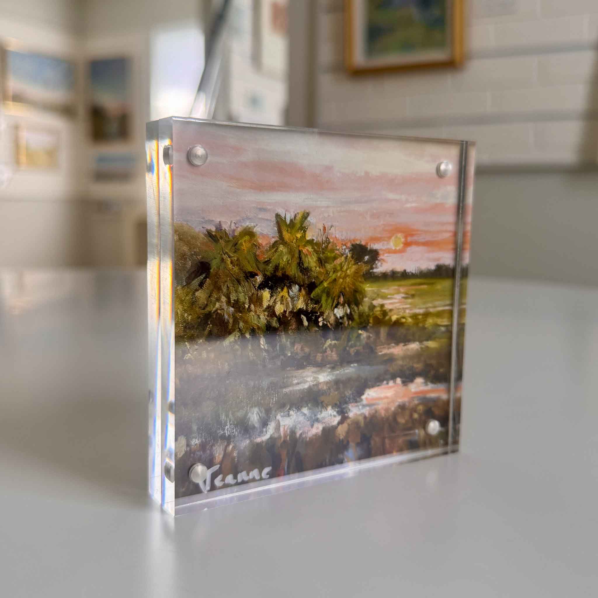Side view of End of the Row acrylic block by local artist Jeanne O’Neal, showing the artwork’s depth and glow, photographed inside Gray Man Gallery.