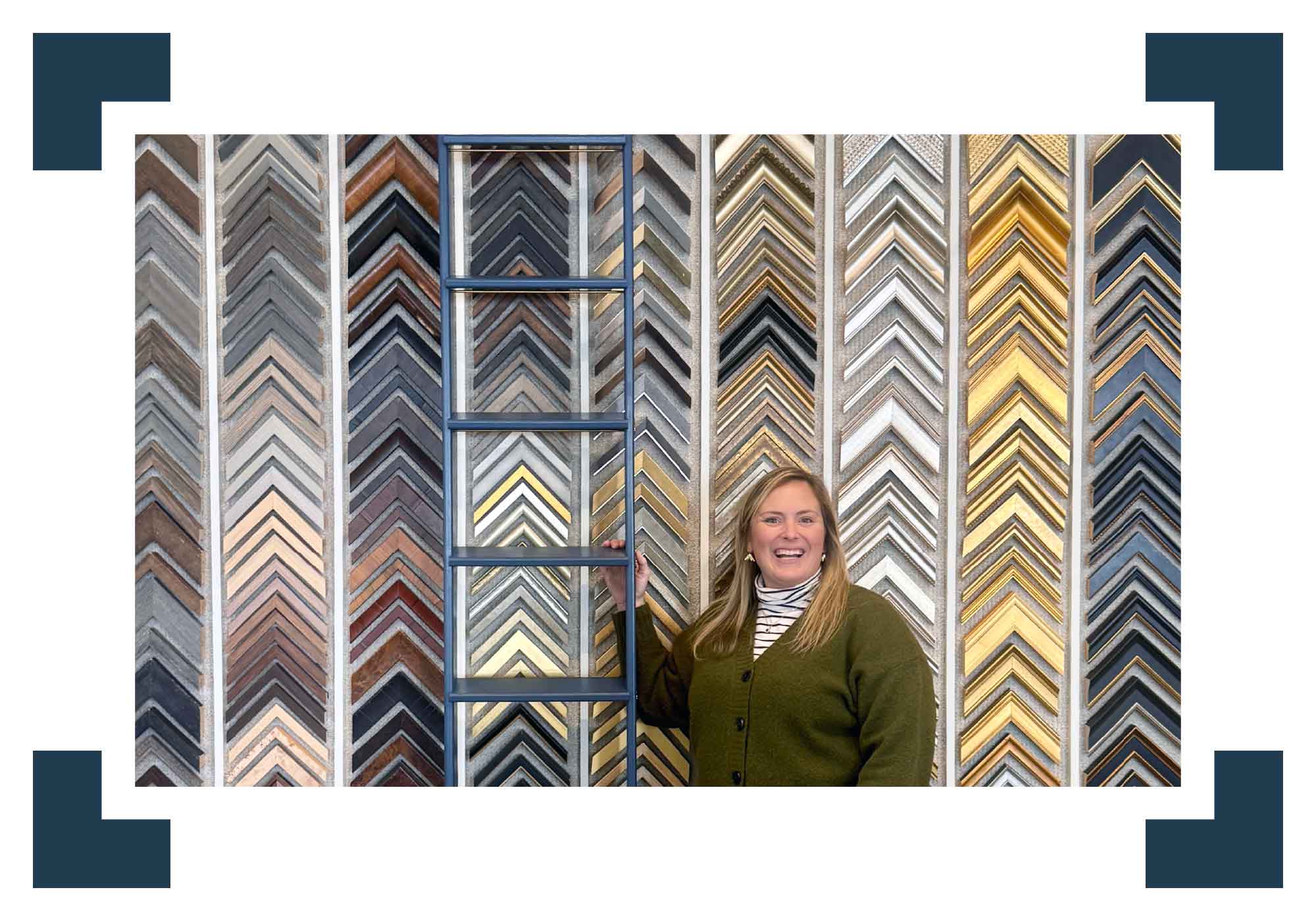 Bordy at Gray Man Gallery’s custom framing studio in Pawleys Island, SC, surrounded by hundreds of frame moulding options, highlighting over 45 years of experience in conservation framing, fine art mounting, textile framing, shadow boxes, and professional presentation of Lowcountry artwork and personal keepsakes