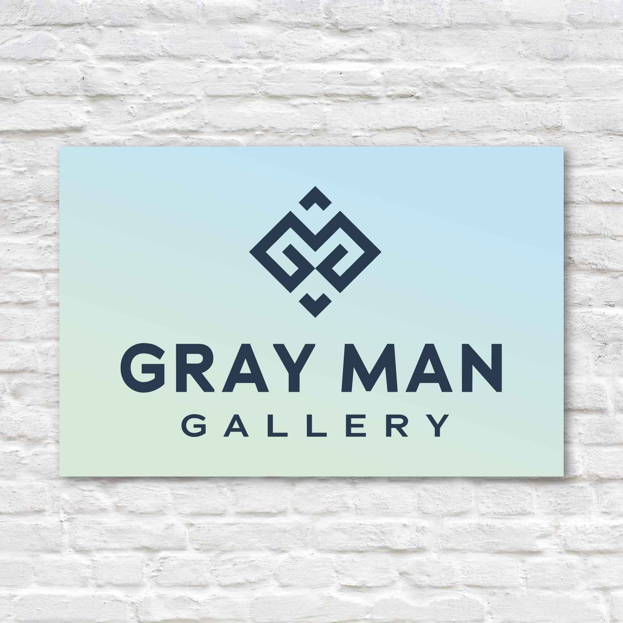 Gray Man Gallery gift card graphic featuring the coastal gradient logo design on a clean white brick background.