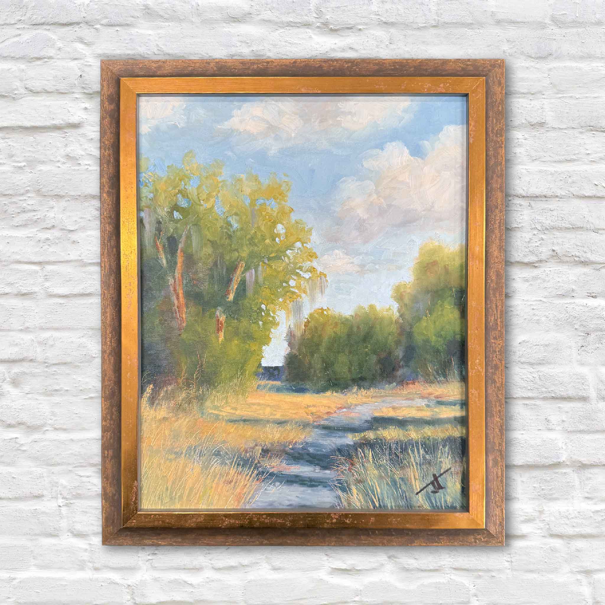 Original 11x14 oil painting titled Light Finds a Way by Jamie Arnold, showing a sunlit Lowcountry path bordered by trees and marsh grasses, framed in a warm gold frame.