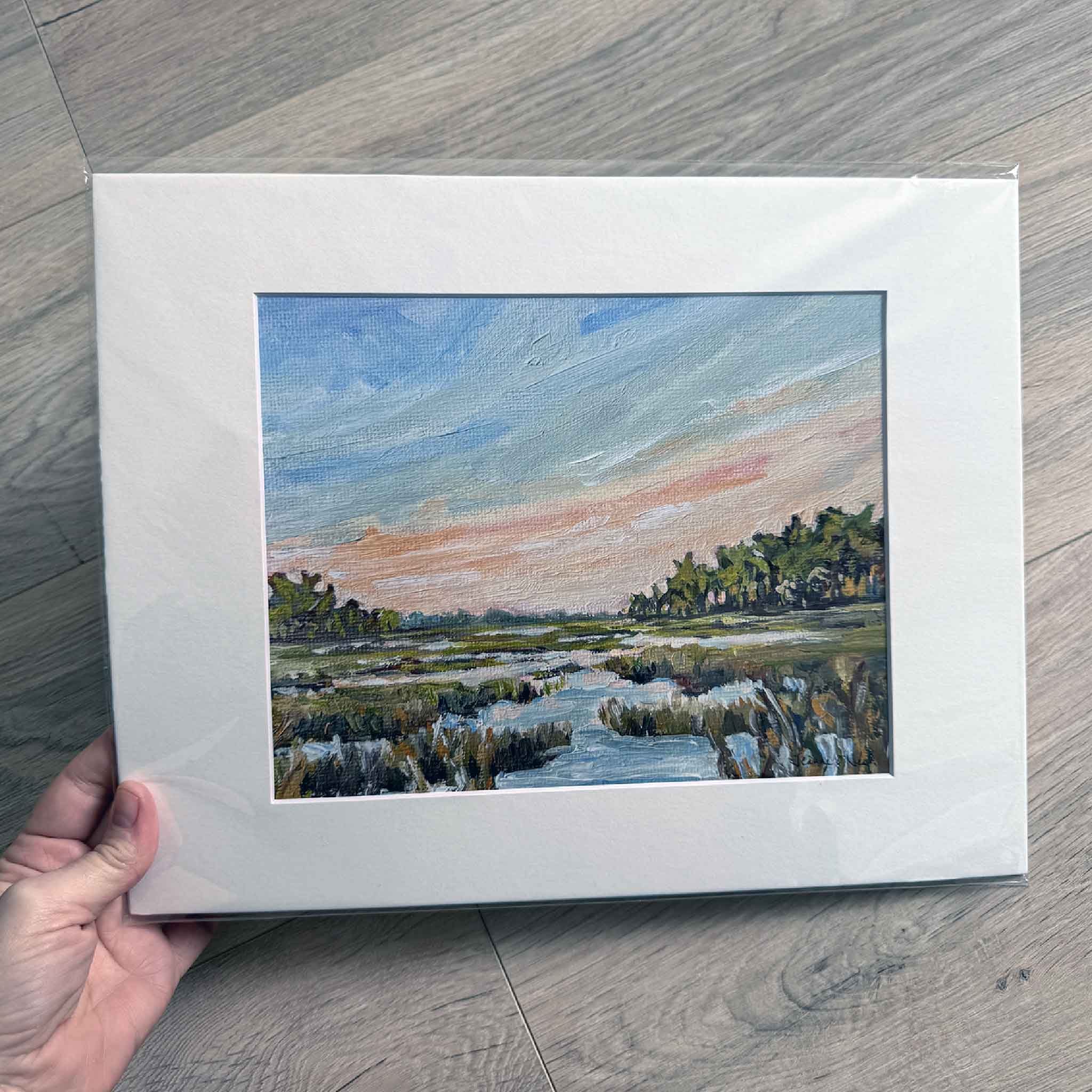 Matted 11x14 art print of Kisses by Jeanne O’Neal, featuring a peaceful Lowcountry marsh at sunset painted in soft coastal pastels.