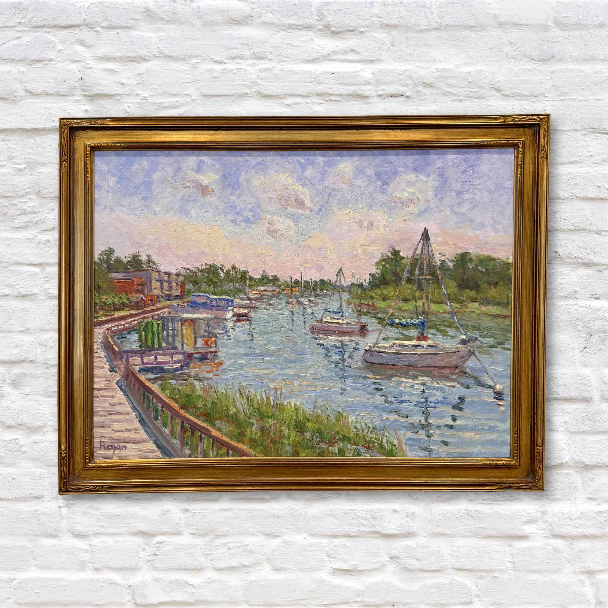 Framed original oil painting titled Georgetown Harbor Walk by Michael Rogan, depicting sailboats in the harbor and the historic Georgetown waterfront with a curved boardwalk. Gray Man Gallery.