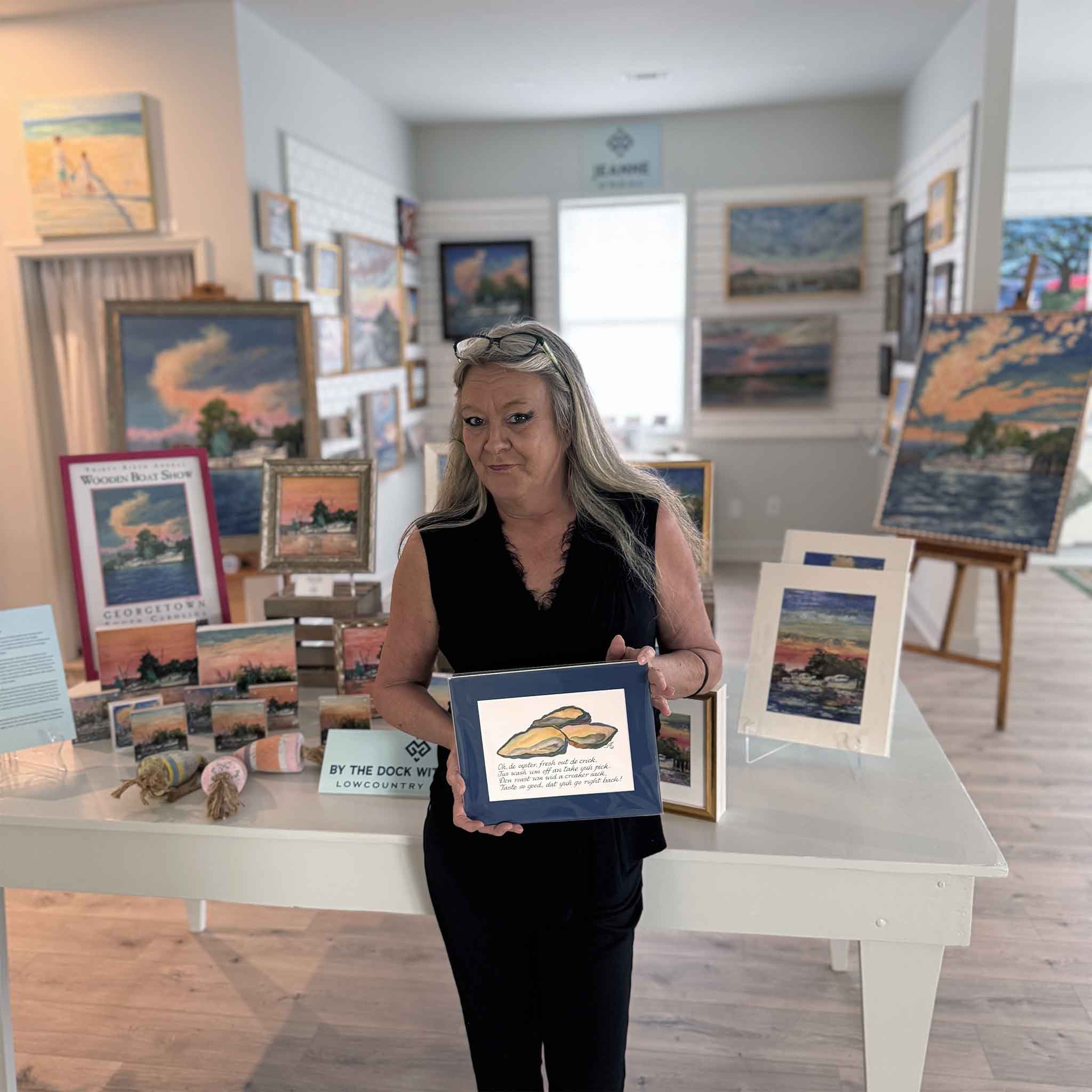 Vida Miller Gullah Odes Oyster matted art print shown held by a gallery team member at Gray Man Gallery, illustrating scale and suitability for coastal kitchens and Lowcountry homes.