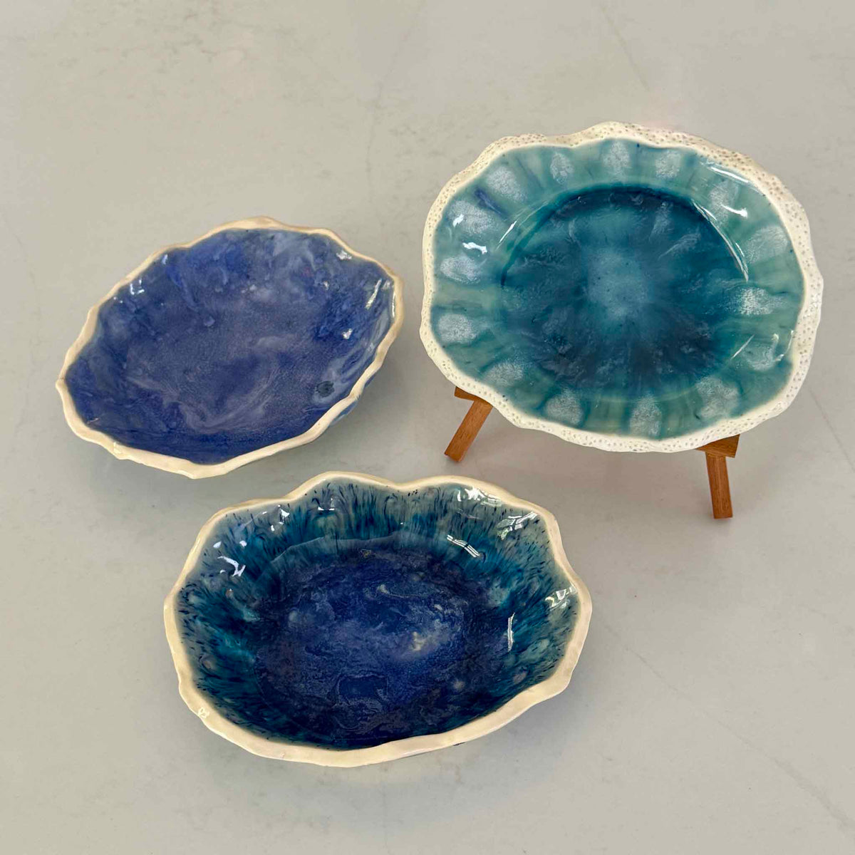 Handmade Marsh Drift Bowls by Pawleys Island artist and Gray Man Gallery founder Vida Miller, shown together in varied organic shapes with layered turquoise, cobalt blue, seafoam and celadon glazes inspired by the South Carolina Lowcountry coast.