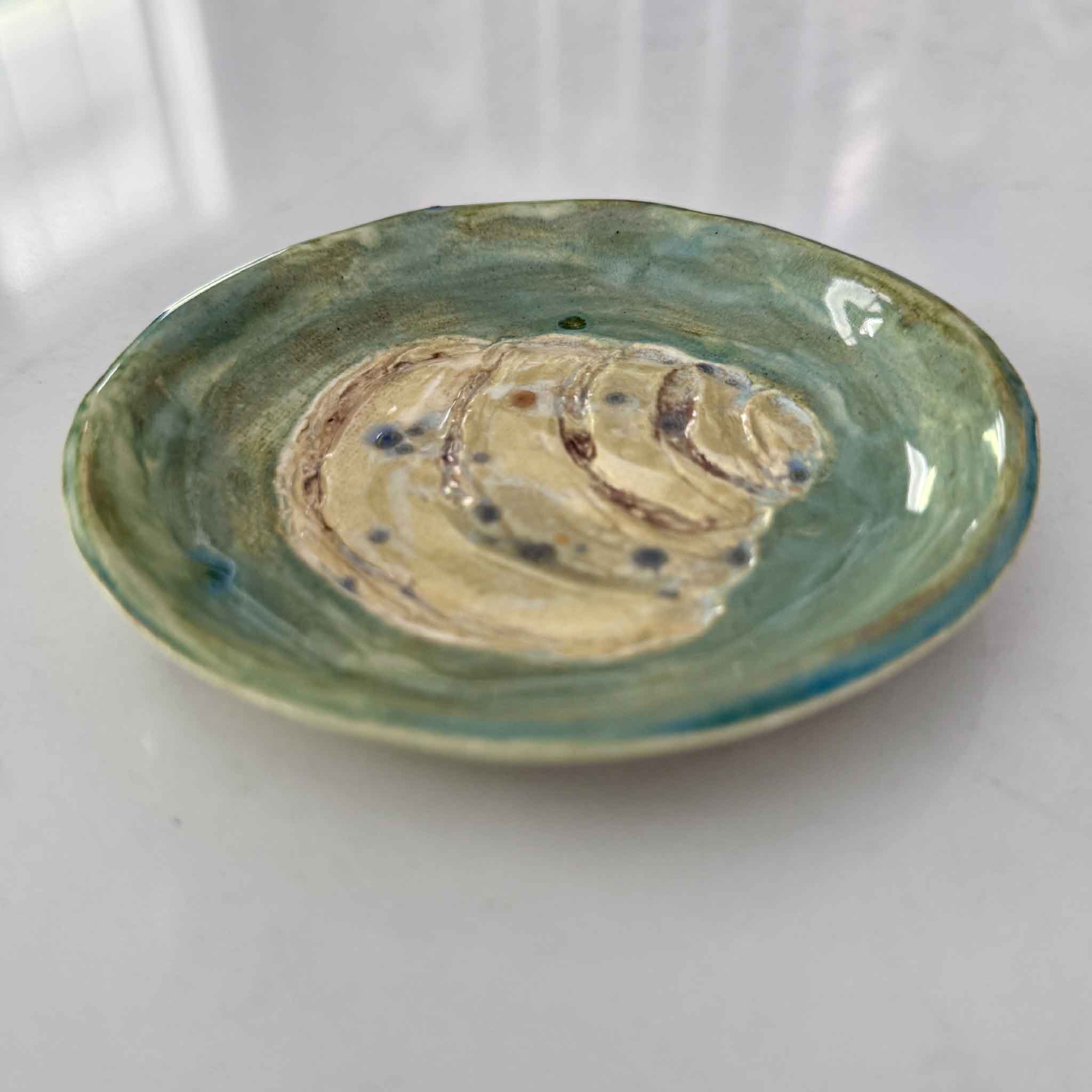 Handmade green Pawleys Island shell dish by local artist Vida Miller Gray Man Gallery ceramic coastal ring dish with raised shell design and glossy glaze detail