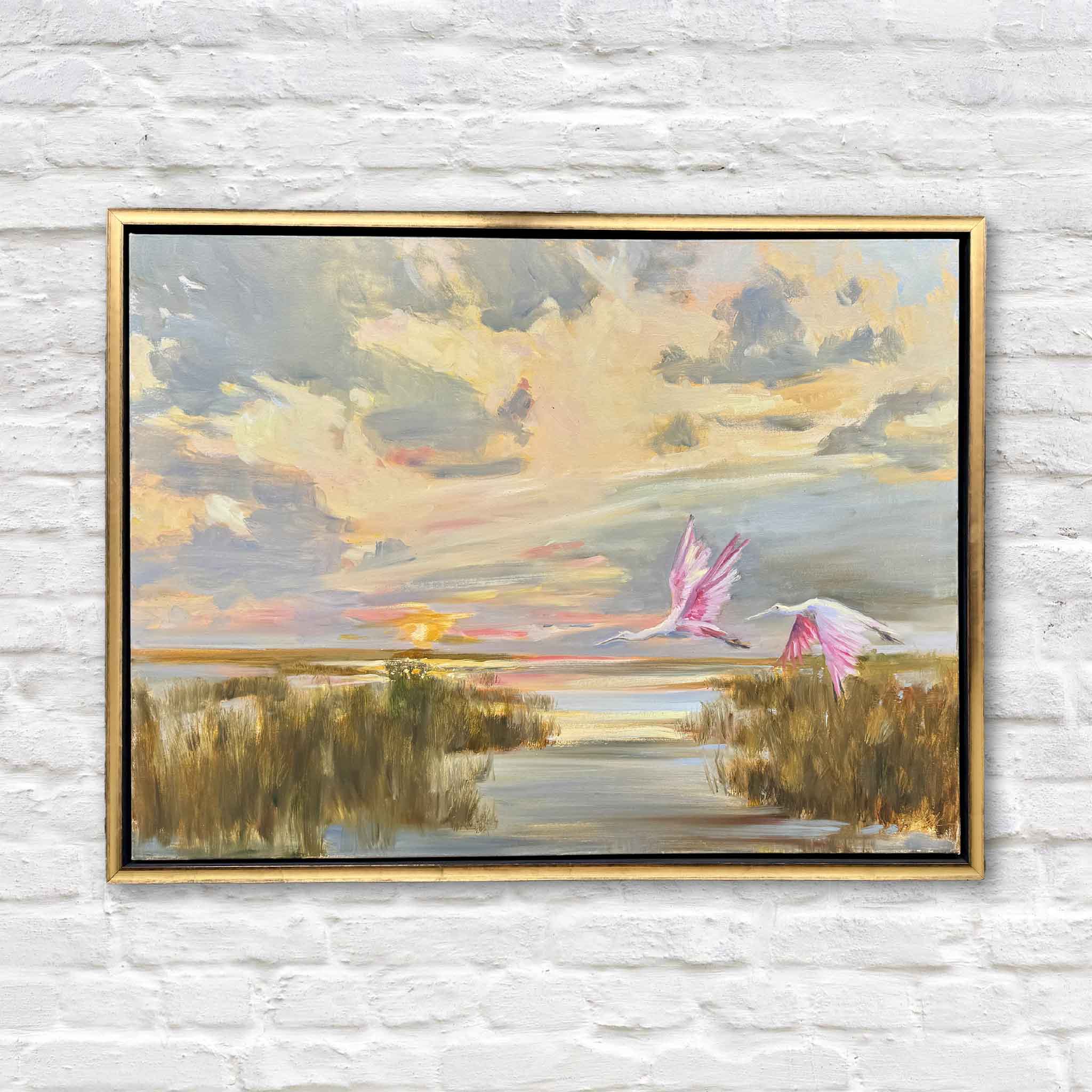 Cruise Control by Helli Luck is an original oil painting featuring two roseate spoonbills flying above a glowing Lowcountry marsh at sunset. Available framed at Gray Man Gallery in Pawleys Island, South Carolina.