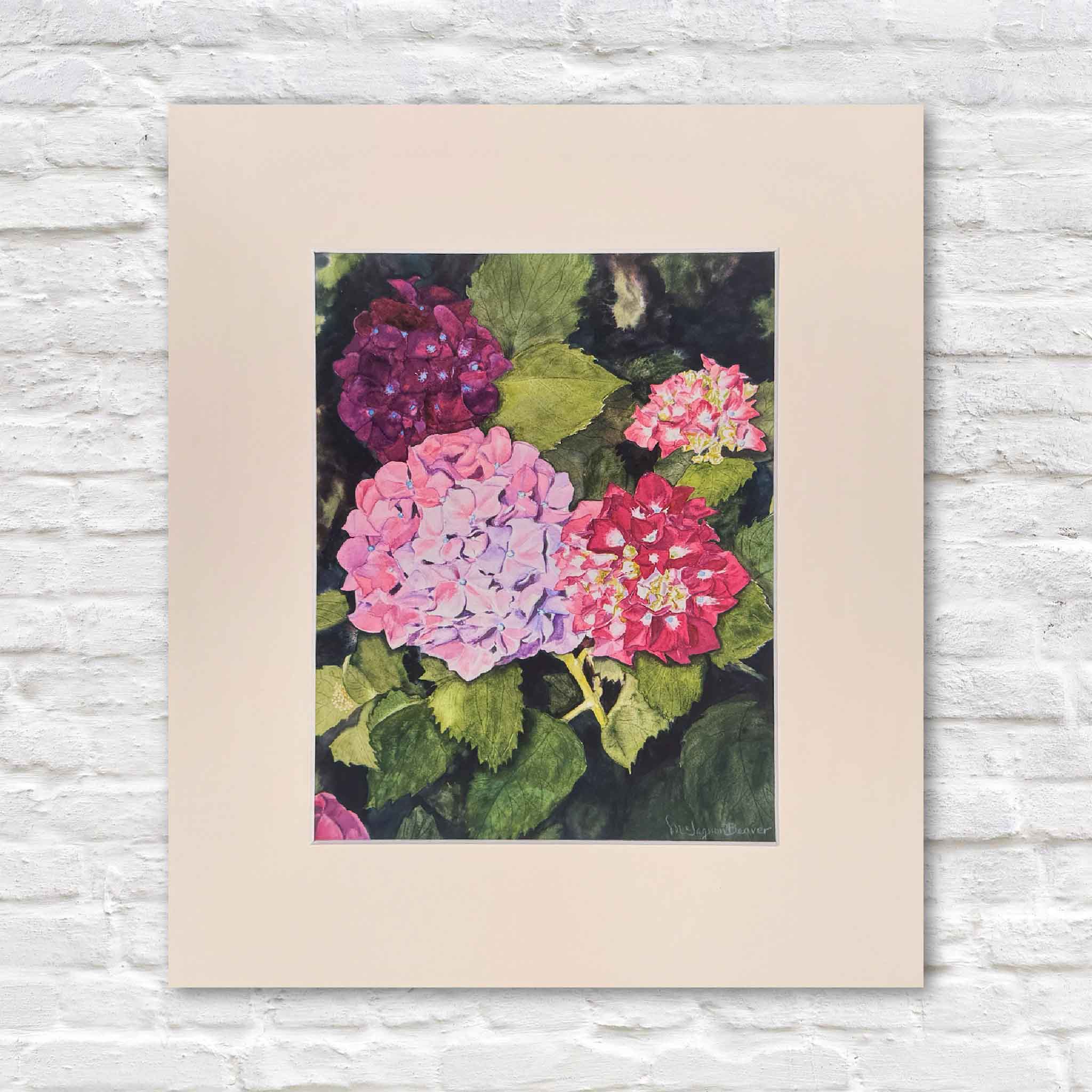 Print of Mimi Beaver’s hydrangea watercolor featuring clusters of purple, pink, and red blooms with deep green leaves, donated to support senior dogs.