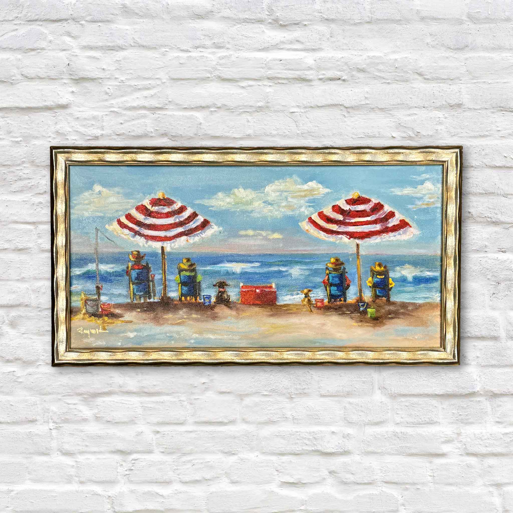 Jenny Reynolds' It's My Beach Too original oil painting, professionally framed in her signature champagne frame and available at Gray Man Gallery in Pawleys Island, South Carolina. This cheerful Lowcountry beach scene features two red-and-white striped umbrellas overlooking the Atlantic Ocean, beach chairs, fishing gear, coolers, playful dogs, and rolling waves beneath a bright blue sky with drifting clouds.