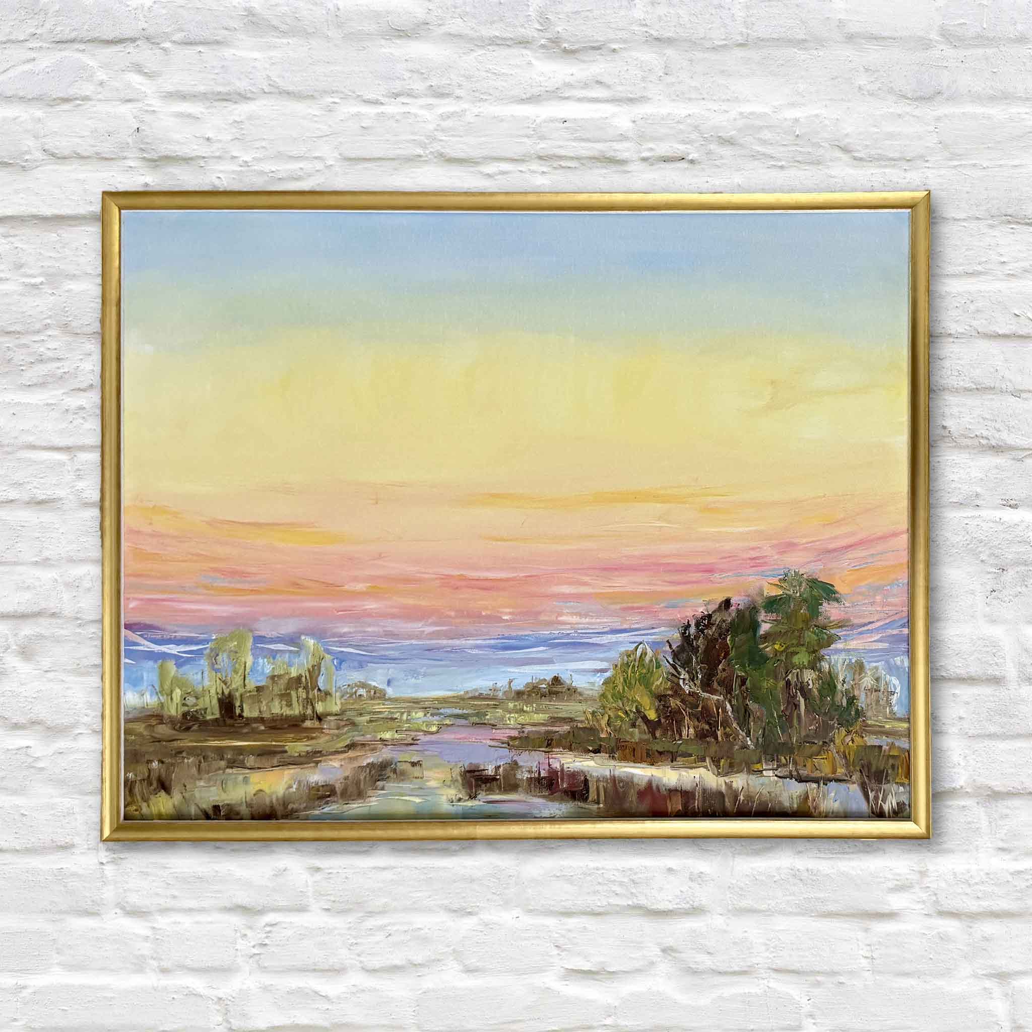 Evening Grace by Jeanne O'Neal is an original framed oil painting capturing a peaceful Lowcountry marsh at sunset beneath glowing yellow, peach, pink, and lavender skies. Available at Gray Man Gallery in Pawleys Island, this expressive coastal landscape showcases Jeanne's evolving painterly style and signature gold frame.